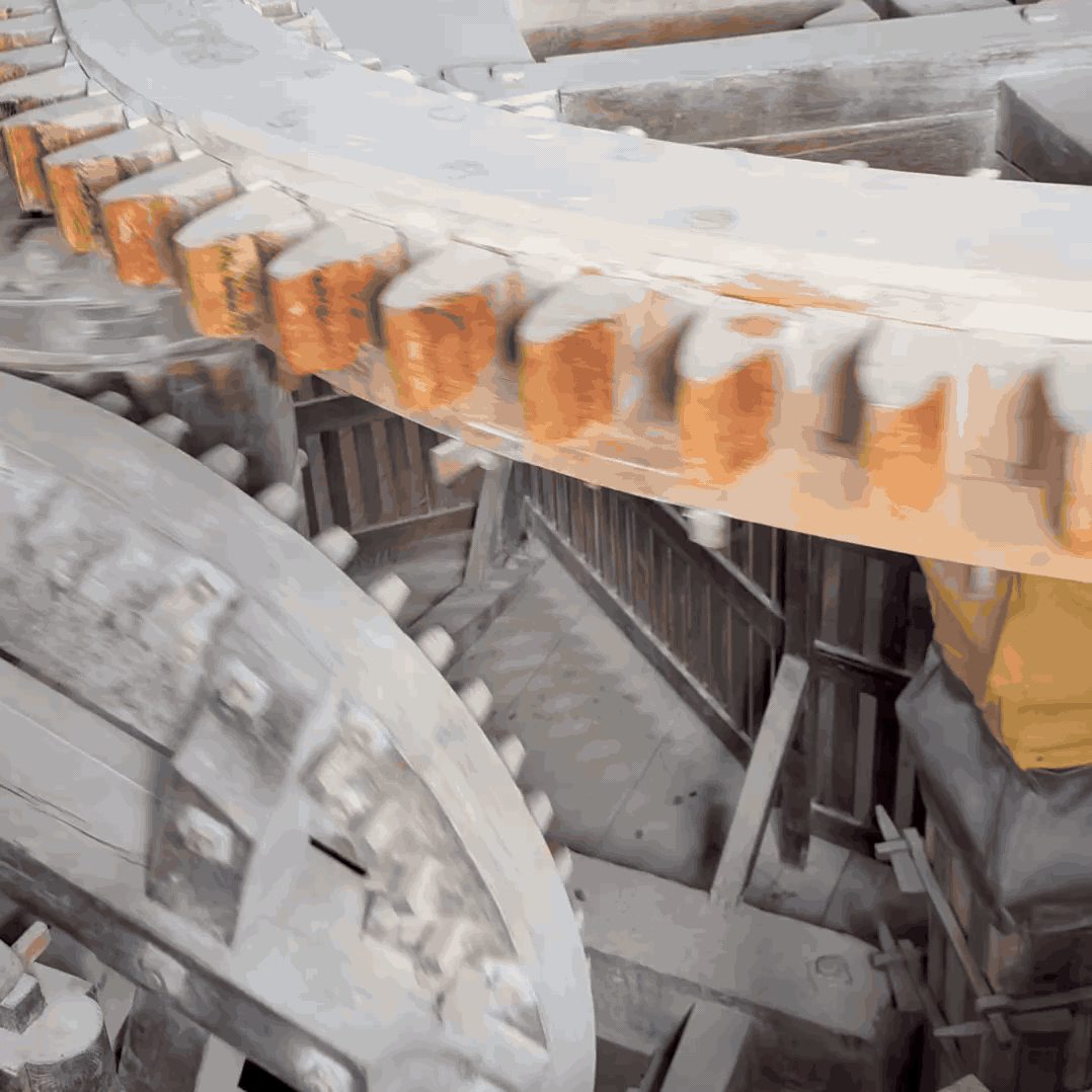 Wooden cogs in a windmill spinning fast with a staircase in the background