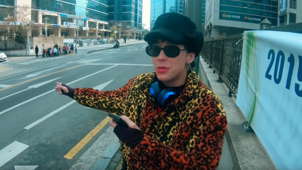 image of AZ wearing earrings, sunglasses, and a leopard-print coat