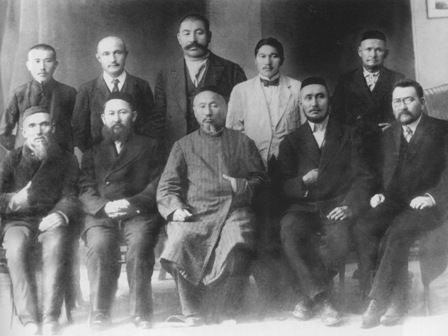 Image of ten men dressed formally, five standing and five sitting, in two rows looking at the camera.