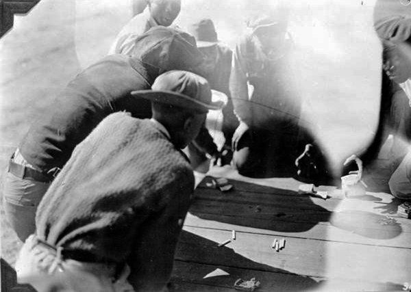 Turpentine workers gamble for cigarettes on payday in Florida ca. 1930s. Hurston visited turpentine camps in Cross City for the Federal Writers’ Project in 1939. State Archives of Florida