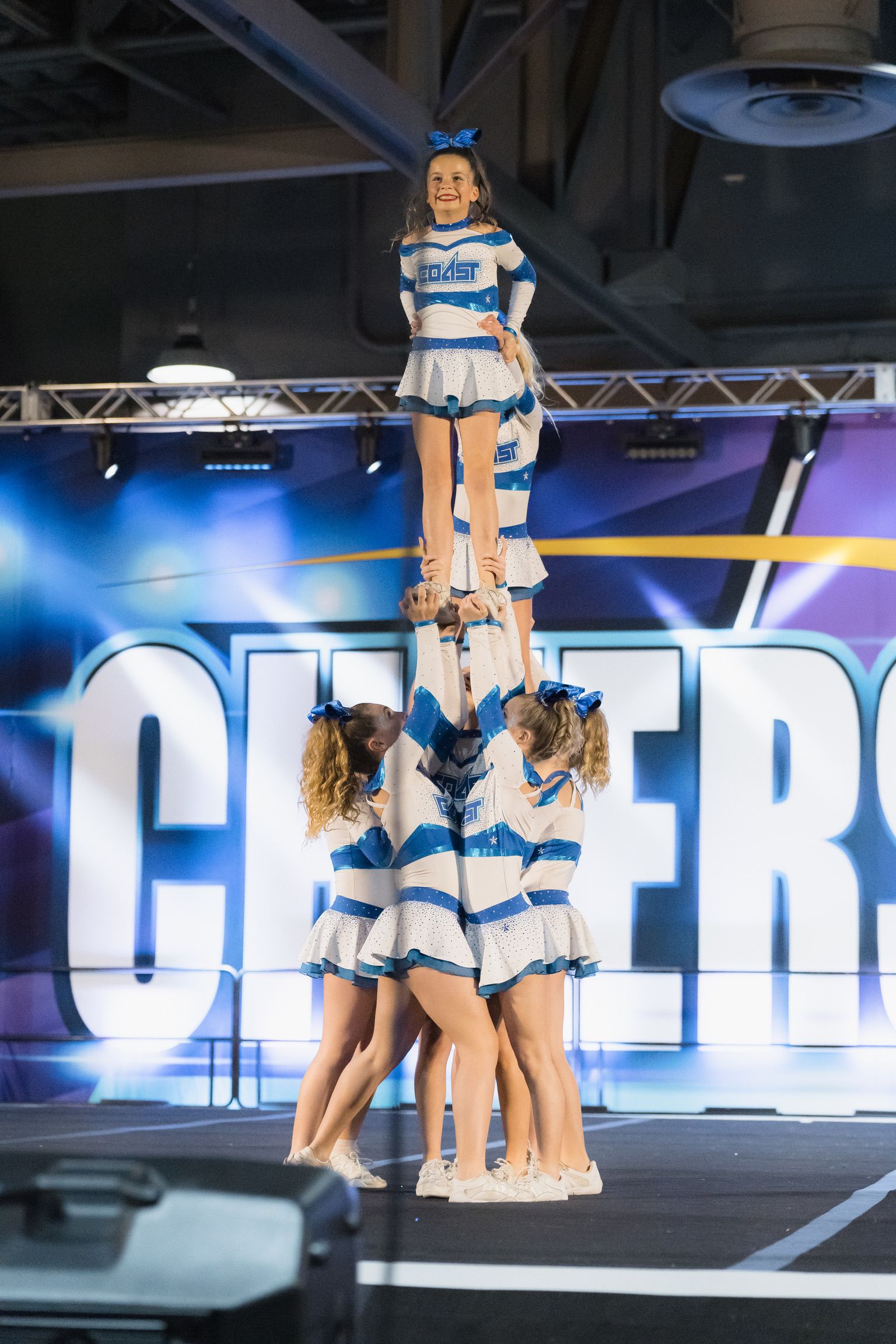 Riley on the top of the cheer pyramid