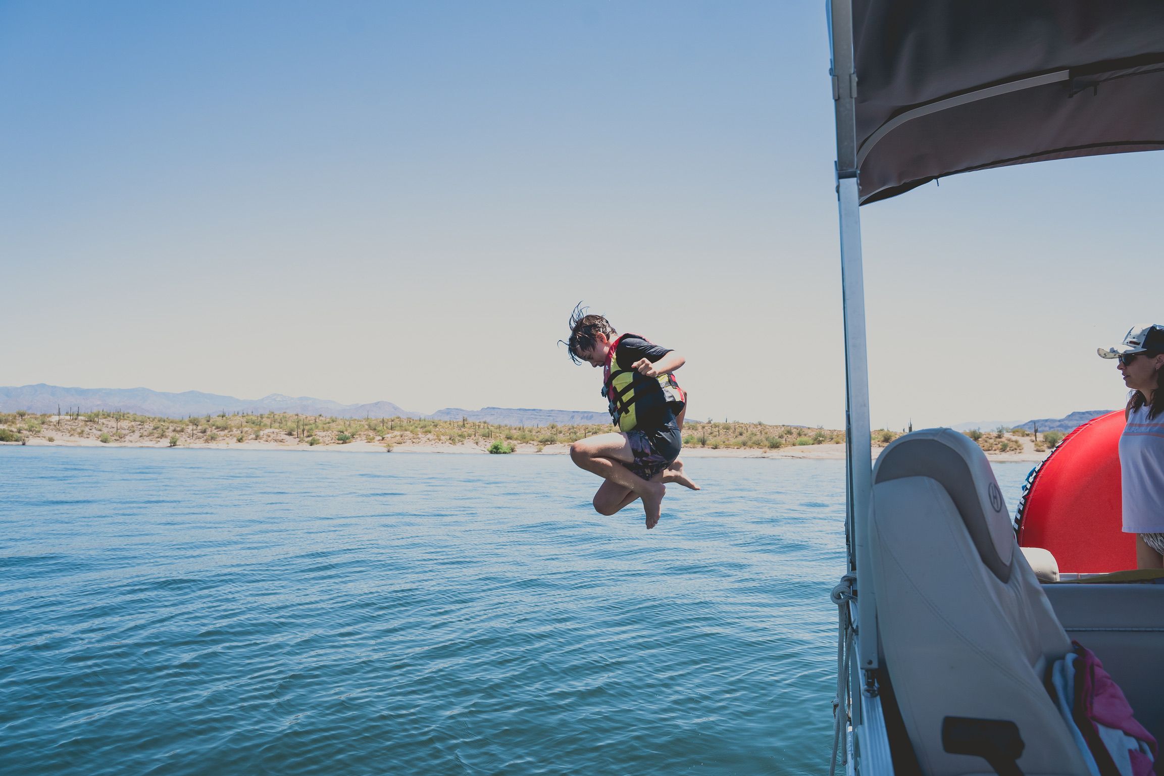 Connor jumping from the boat into the lake in Arizona