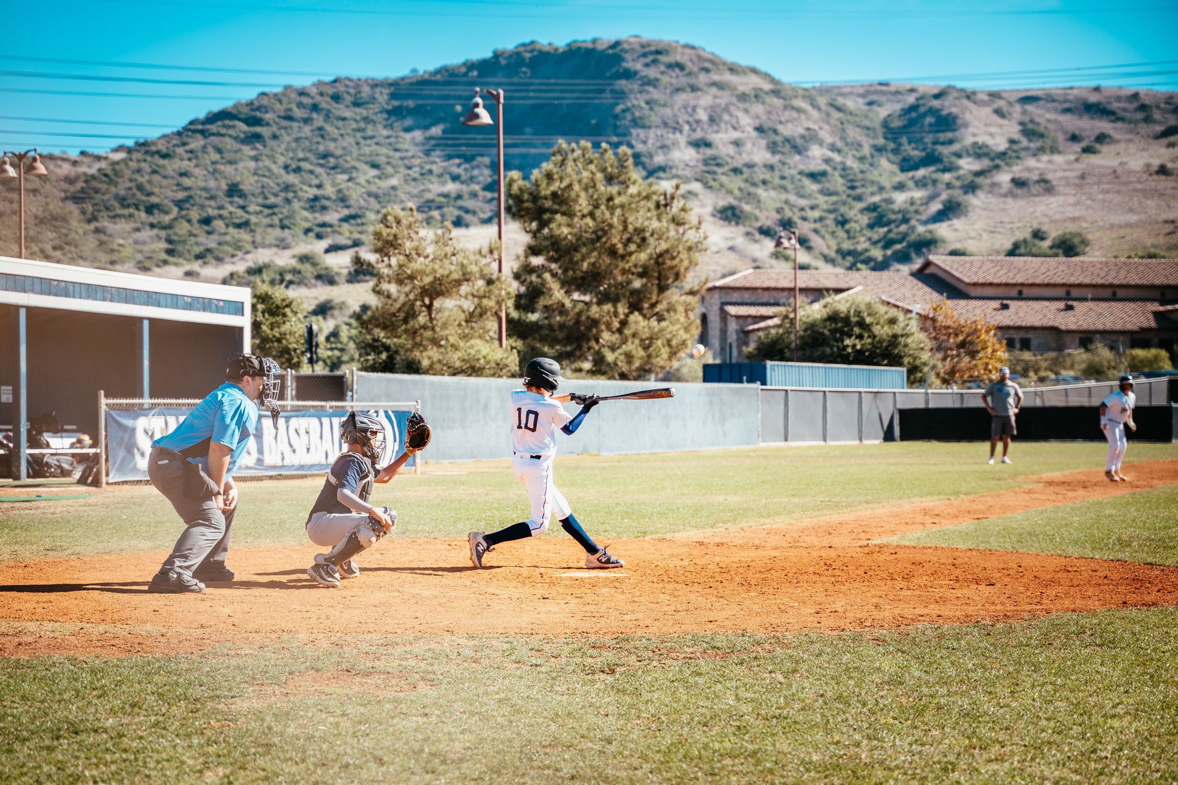 Connor driving in a run on the high school field in 13u baseball
