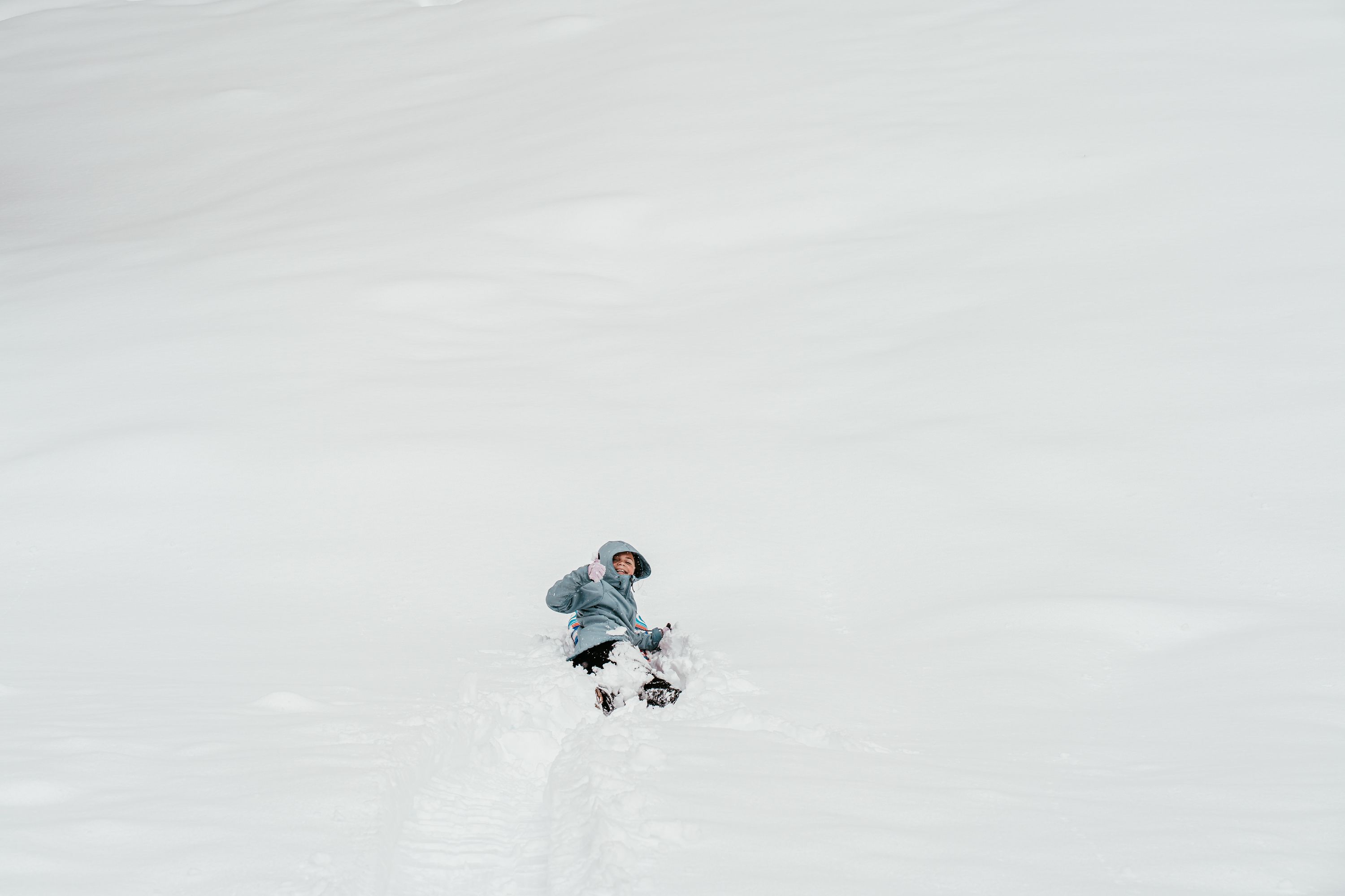 Riley attempts sledding in a whiteout