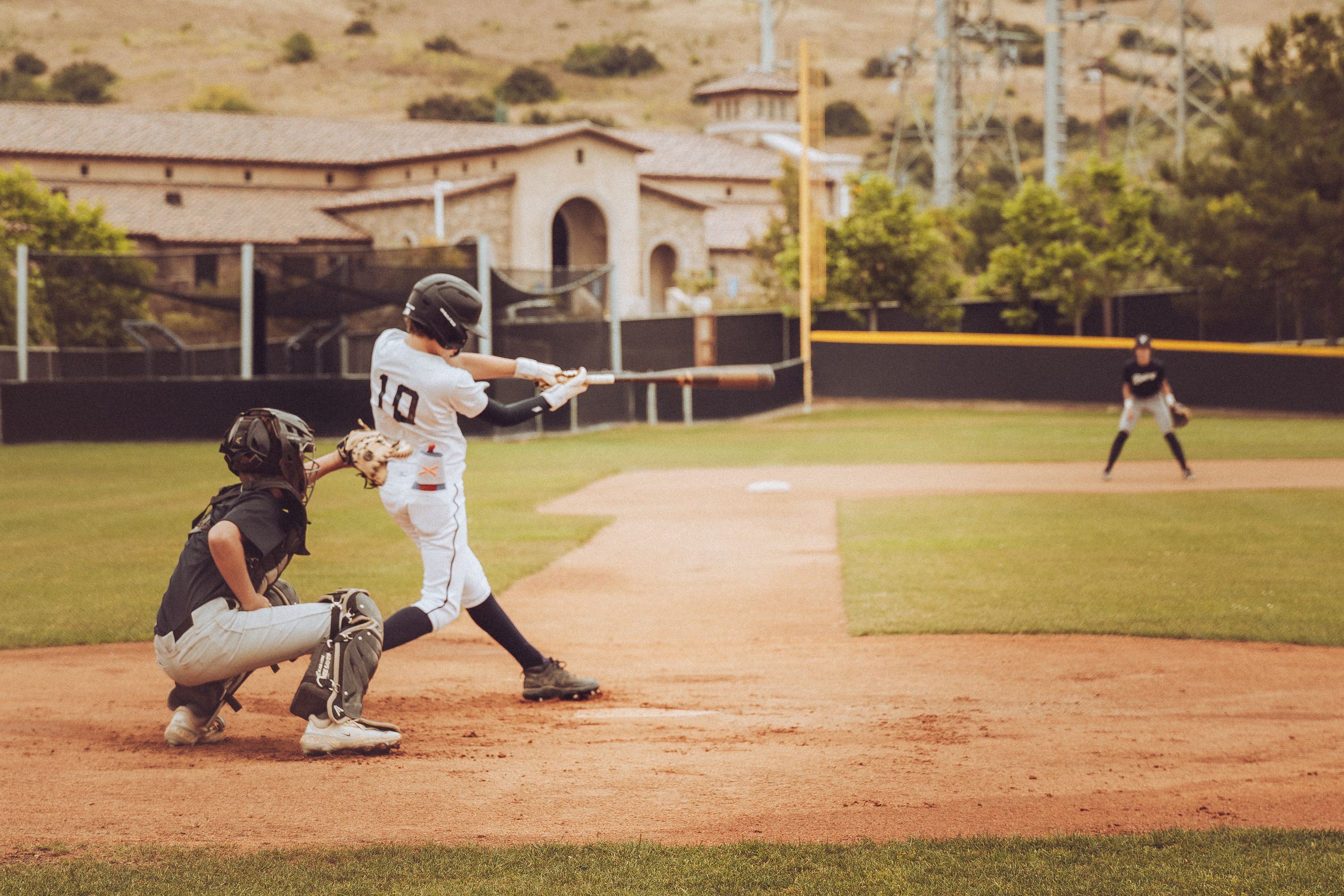 Connor taking a swing in 13u baseball