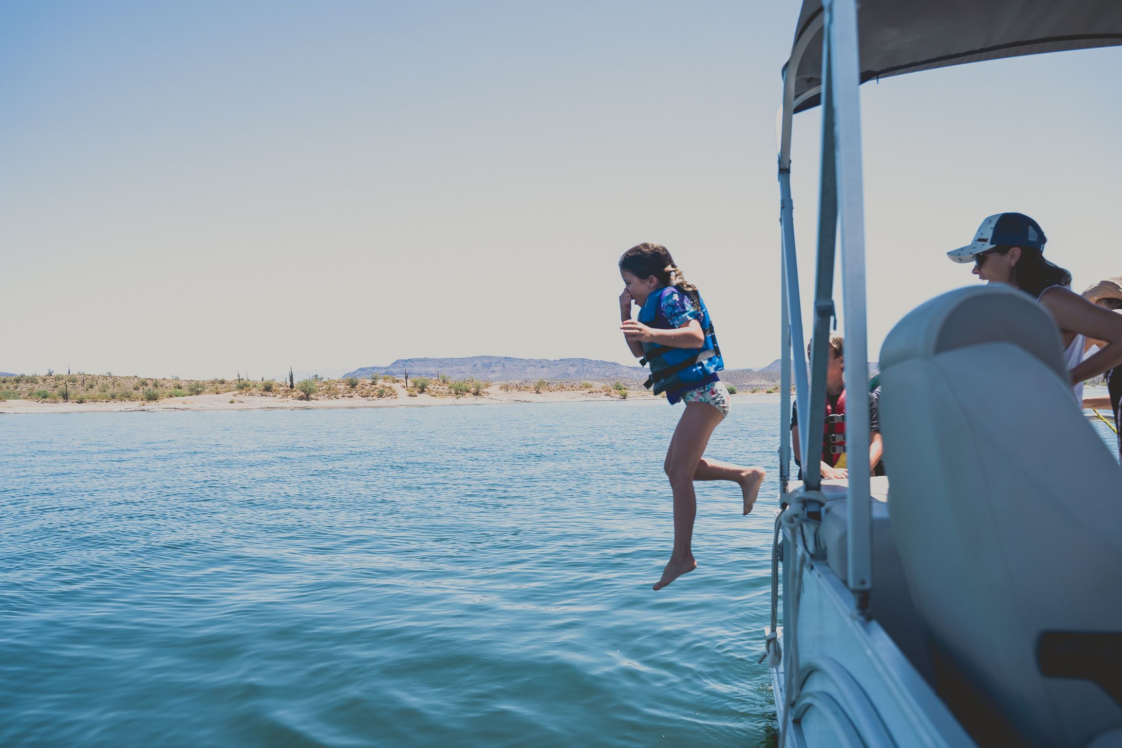 Riley jumping from the boat into the lake in Arizona