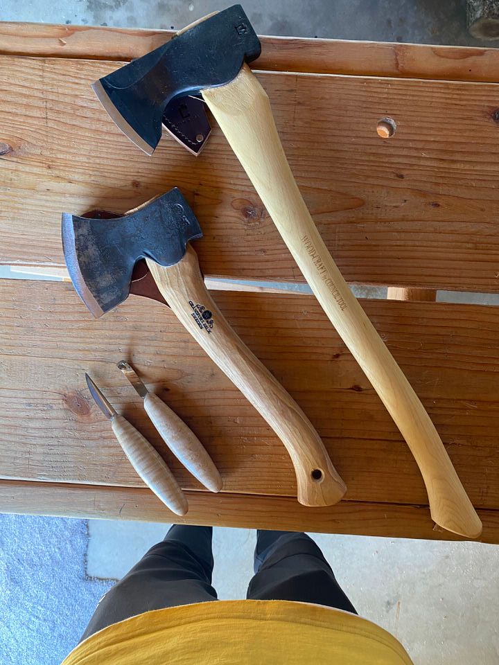 Small felling axe, “Woodcraft” by Council Tool Company in North Carolina. Large carving axe by Gränsfors Bruk in Sweden. Small sloyd knife and hook knife from Pinewood Forge in Minnesota.