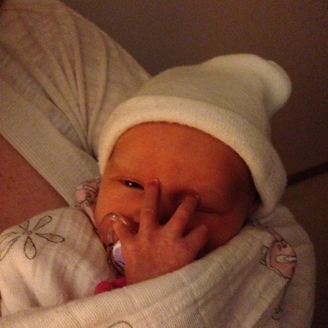 Baby Siena peeking through her tiny hand.