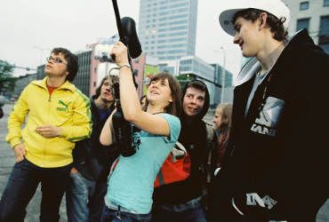 A group of people with recording gear looking skyward