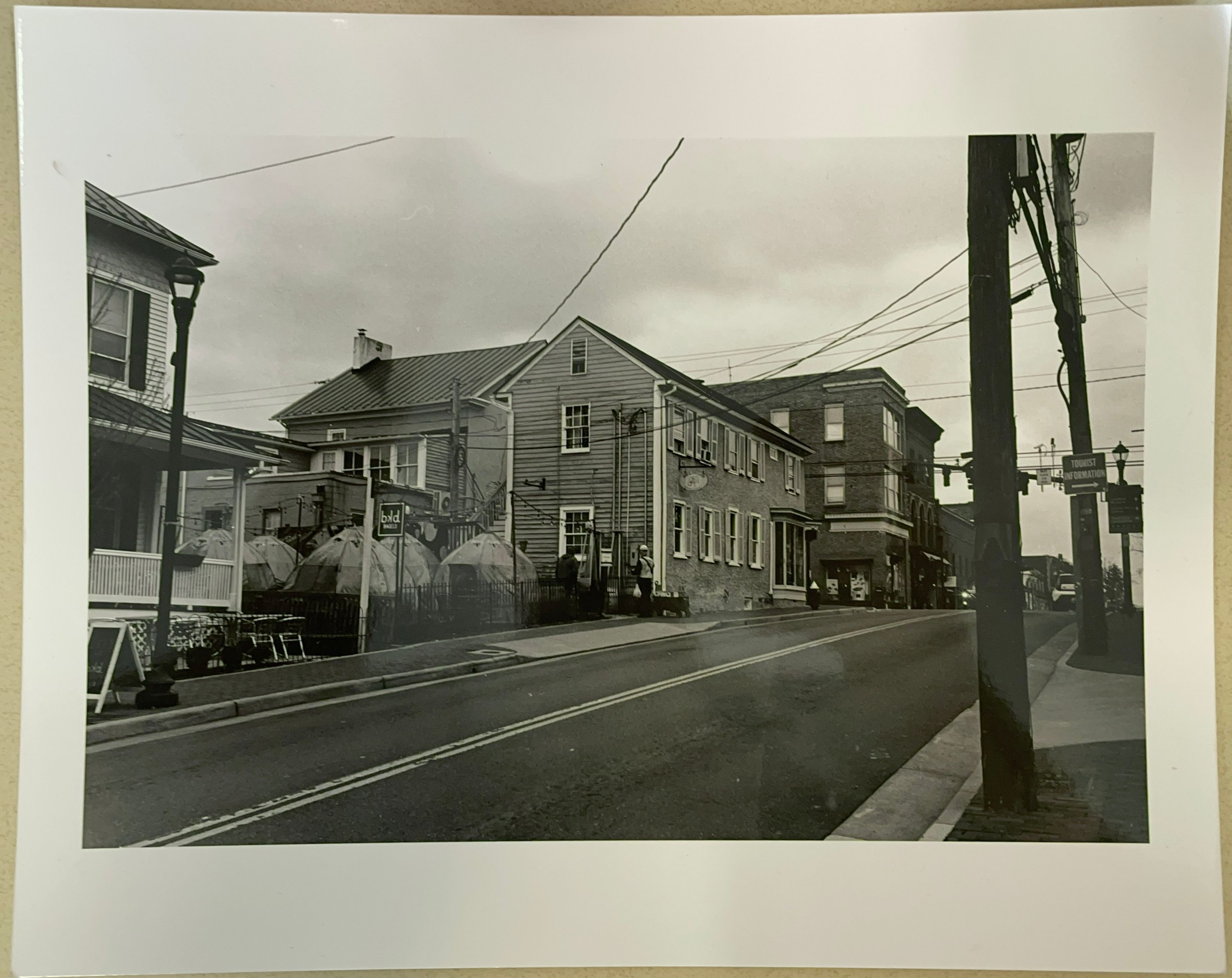A glossy paper print of a black and white image of Delirium Café and other old buildings on King Street in Leesburg, Virgina