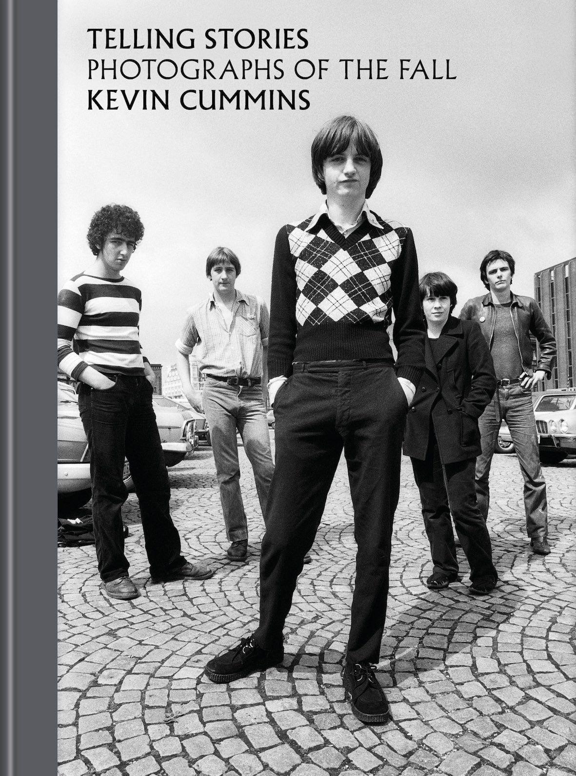 The band The Fall standing on a cobblestone street is the front cover black-and-white photo for the Kevin Cummins book Telling Stories, Photographs of The Fall