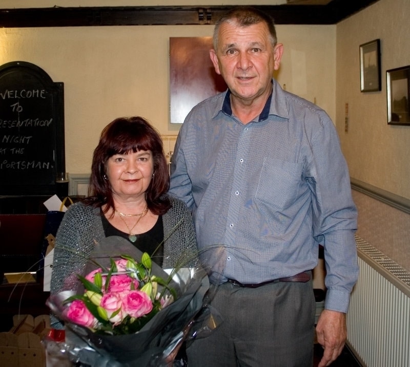Belle Landlady of the Sportsman Inn receiving flowers from Bob McKie