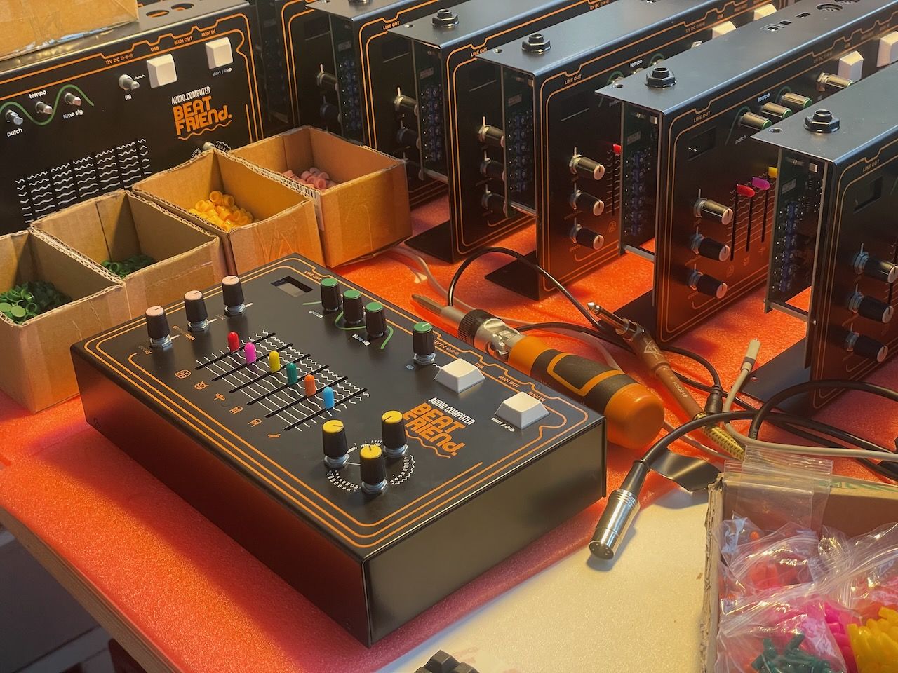 a table full of half-assembled Beat Friends