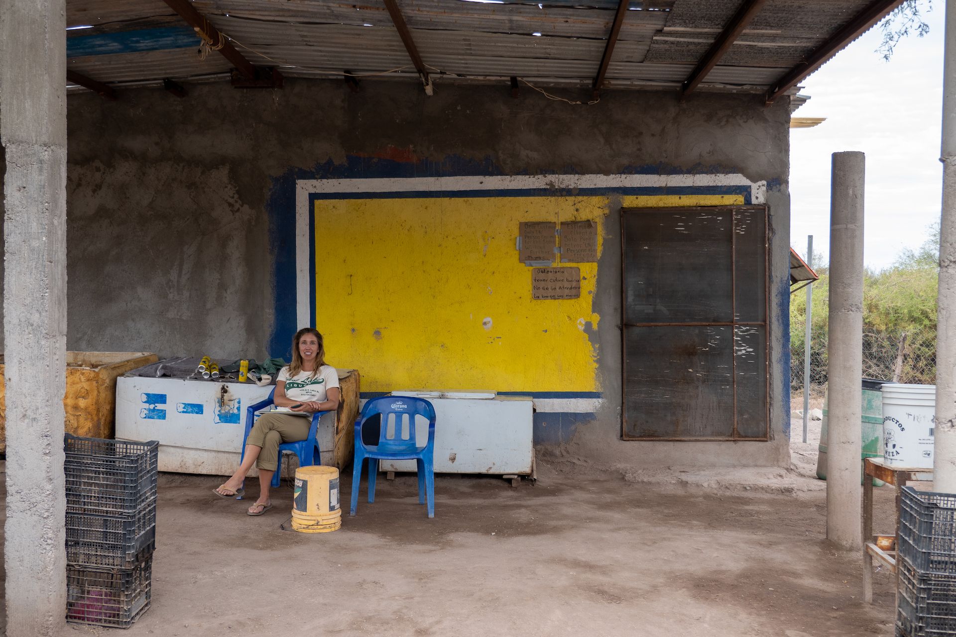 Beth enjoying a cold beer and WiFi (30 pesos/hour) in front of the store