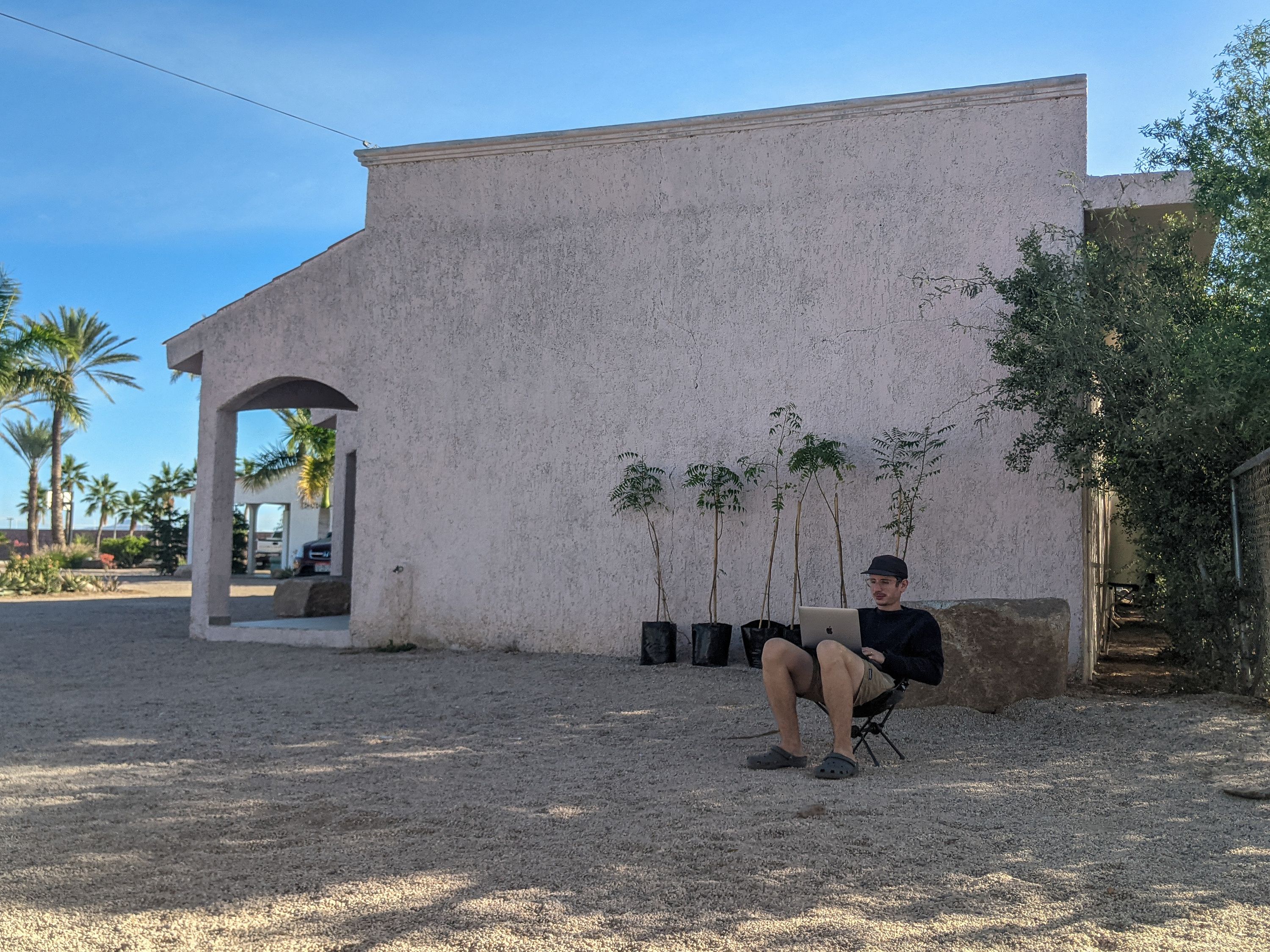 Victor working on our blog post in the shade of the little casita next to our camp spot