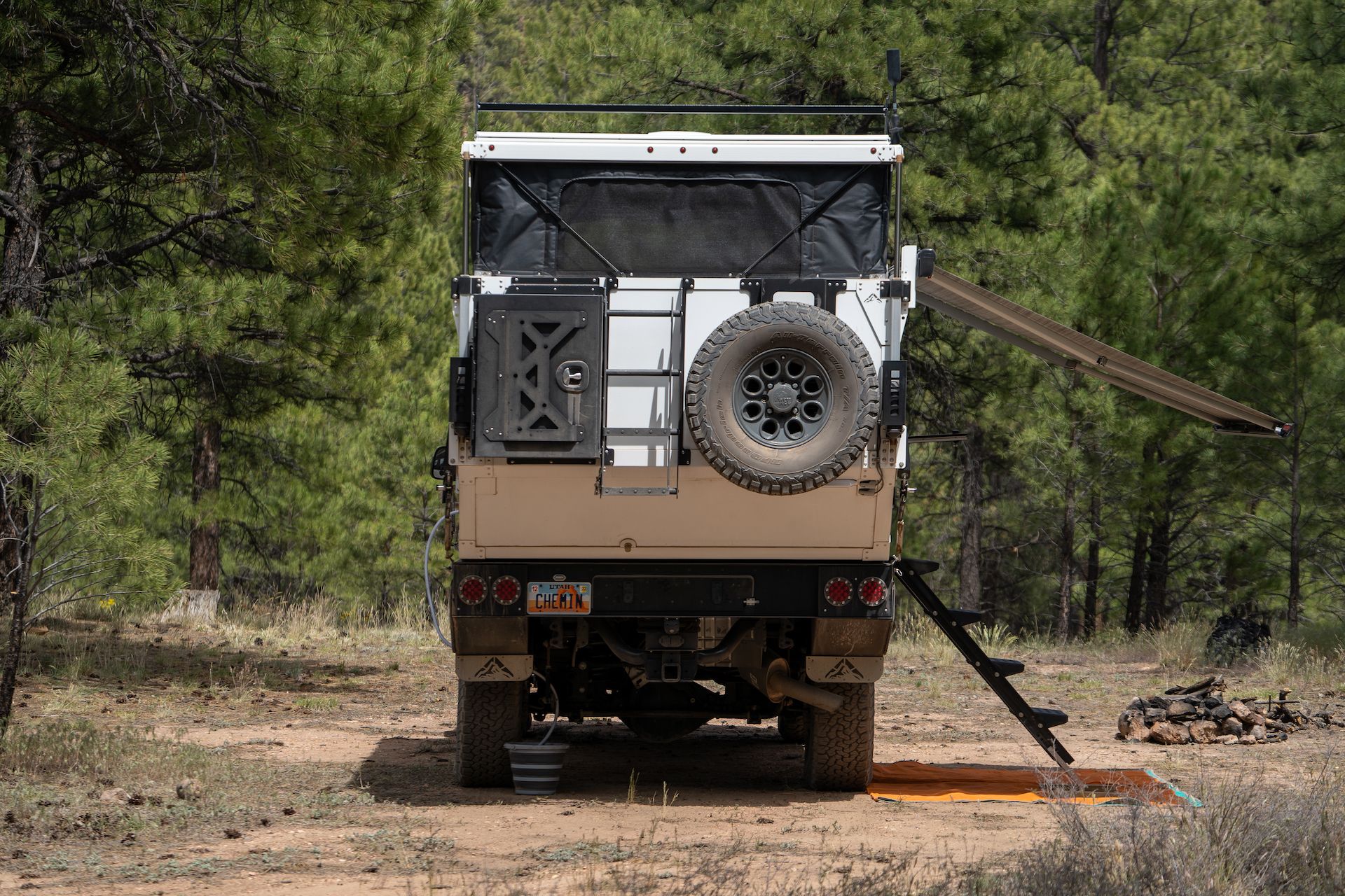 The spare tire mounted on the back of the camper