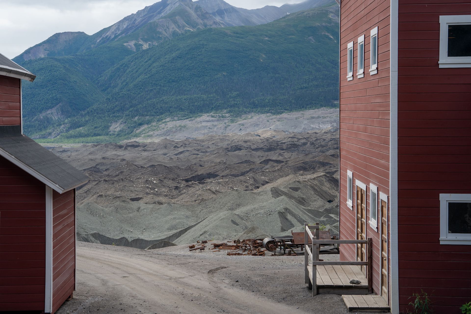 The mine was built alongside the Kennicott Glacier. The “dirt” that you see behind the building was not coming from the mines, but was actually a moraine, debris pushed by the glacier on top of the ice layer.