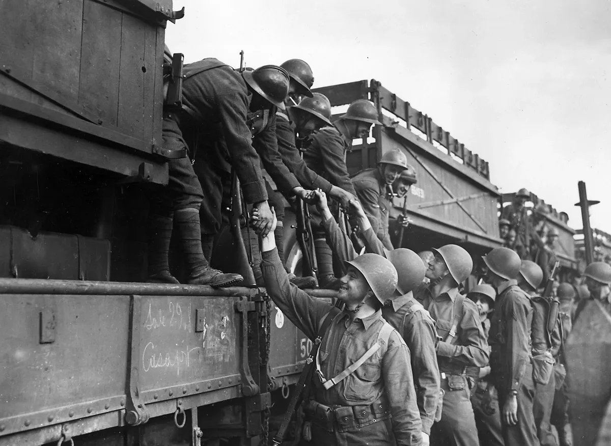 Tunisia-bound French soldiers shake hands with their American allies in Algeria, 1943