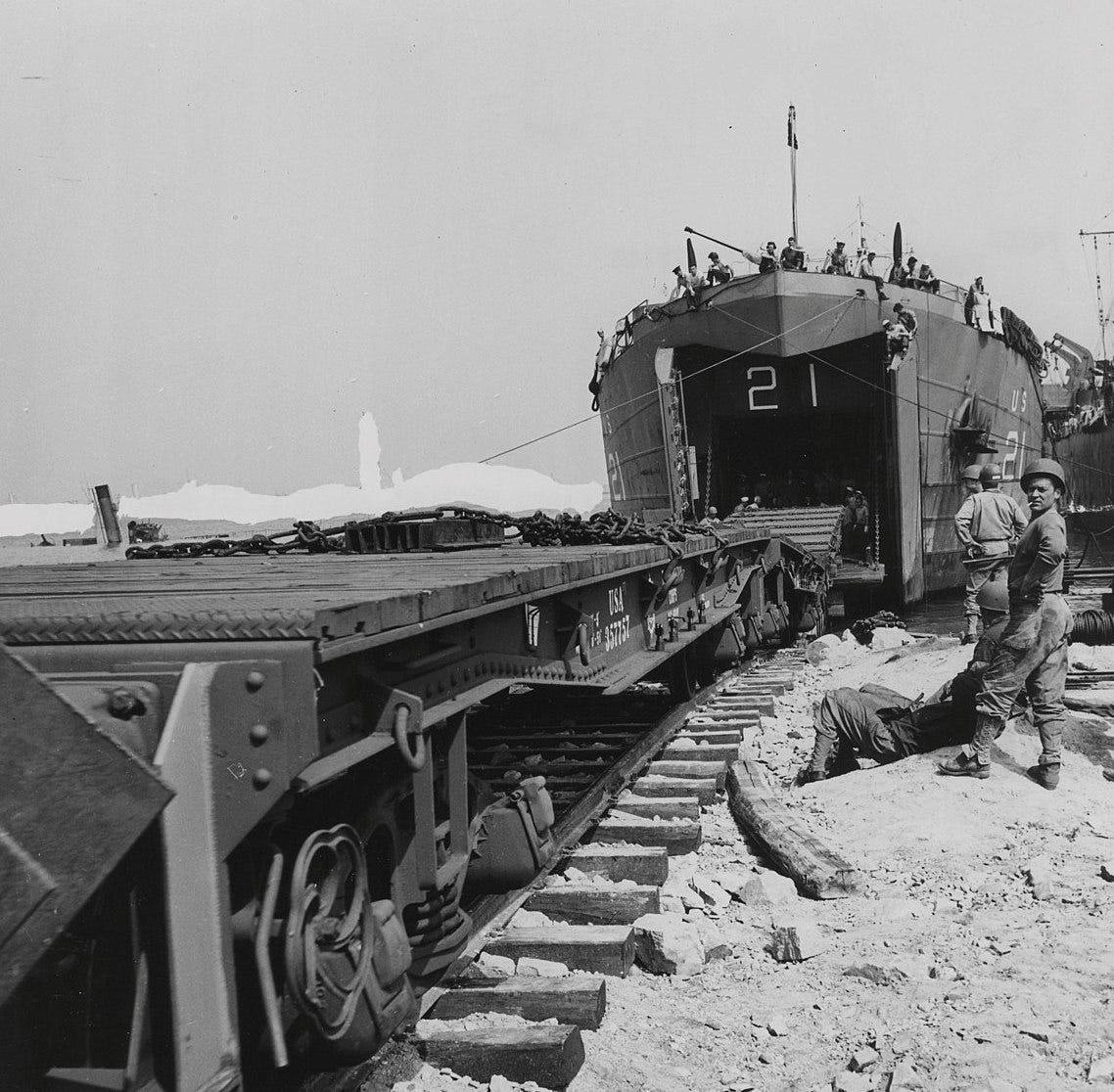 A Landing Ship Tank (LCT) prepares to disgorge its supplies onto an Allied railway system. 