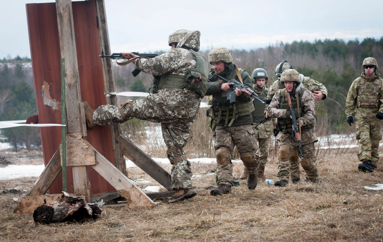 A Ukrainian combat training center engineer kicks in a door after using a breaching charge while training with Canadian and U.S. Army engineers to build their breaching skills, enabling them to teach those skills to Ukrainian army units who will rotate through the combat training center at the International Peacekeeping and Security Center, near Yavoriv, Ukraine, on Feb. 23. (DVIDS, Photo by Sgt. Anthony Jones, 45th Infantry Brigade Combat Team)