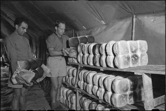 New Zealanders manning a field bakery in Italy prepare their loaves for delivery. Photo taken by George Kaye. Image courtesy of NZ National Library.