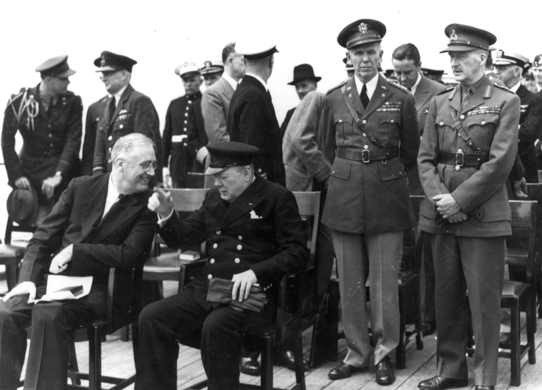 Marshall and Dill stand behind President Franklin D. Roosevelt (left) and Prime Minister Winston Churchill (right) on HMS Prince of Wales in Placentia Bay, Newfoundland, August 10, 1941. Dill became head of the British Joint Staff Mission in Washington D.C. in January 1942, where he sat as a permament British member of Combined Chiefs of Staff.