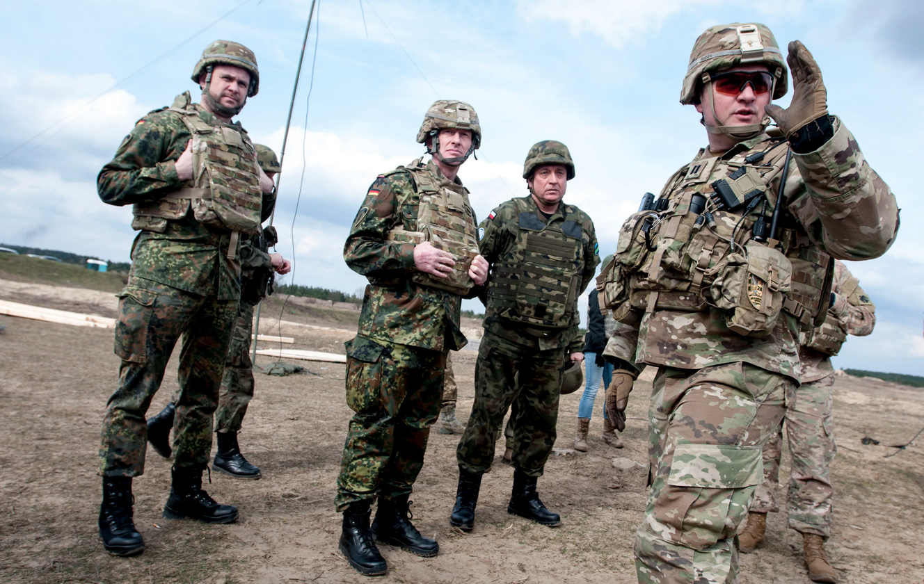 Capt. Matthew McCoy, commander of Alpha Company, 1st Battalion, 179th Infantry Regiment, 45th Infantry Brigade Combat Team, Oklahoma Army National Guard and a resident of Oklahoma City, briefs German Brig. Gen. Kai Rohrschneider, chief of staff of U.S. Army Europe (second from left) and Polish Maj. Gen. Jan Śliwka (second from right) about how Ukrainian soldiers have planned a defensive position during live-fire training at the Yavoriv Combat Training Center at the International Peacekeeping and Security Center, near Yavoriv, Ukraine, on March 21, 2017. (DVIDS, Photo by Sgt. Anthony Jones, 45th Infantry Brigade Combat Team)