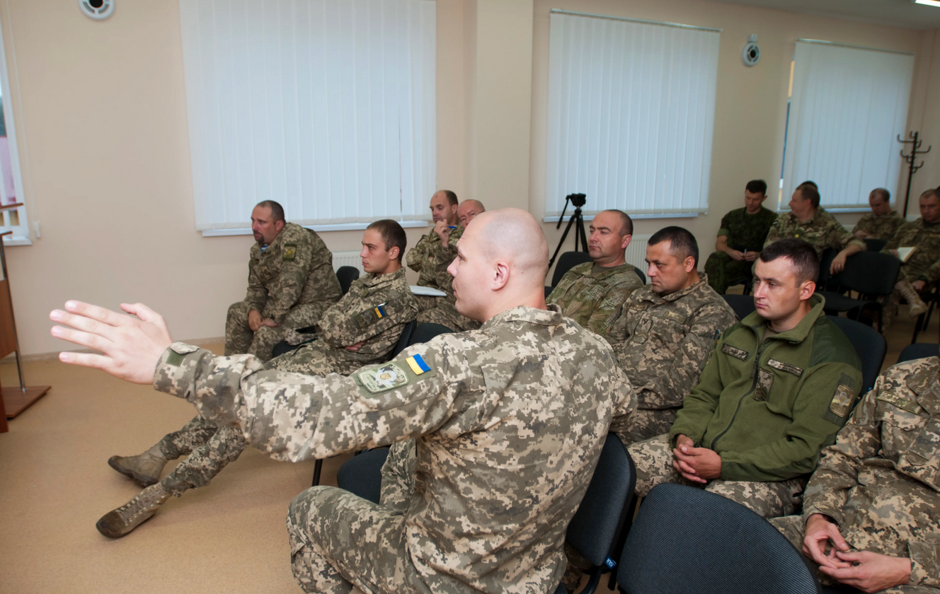 Officers of Ukraine’s 1st Battalion, 95th Separate Airmobile Brigade participate in an after-action review after a computer assisted command post exercise held at the Yavoriv Combat Training Center Simulations Center on September 4, 2017. (DVIDS)