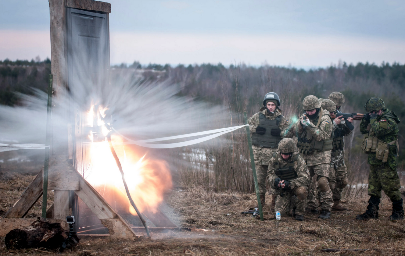 Ukrainian combat training center engineers detonate an explosive charge to breach a door before entering a mock building as part of training with Canadian and U.S. engineers to build the Ukrainian’s breaching skills, at the International Peacekeeping and Security Center, near Yavoriv, Ukraine, on Feb. 24, 2017 enabling them to teach those skills to Ukrainian army units who will rotate through the IPSC. (DVIDS, Photo by Sgt. Anthony Jones, 45th Infantry Brigade Combat Team)