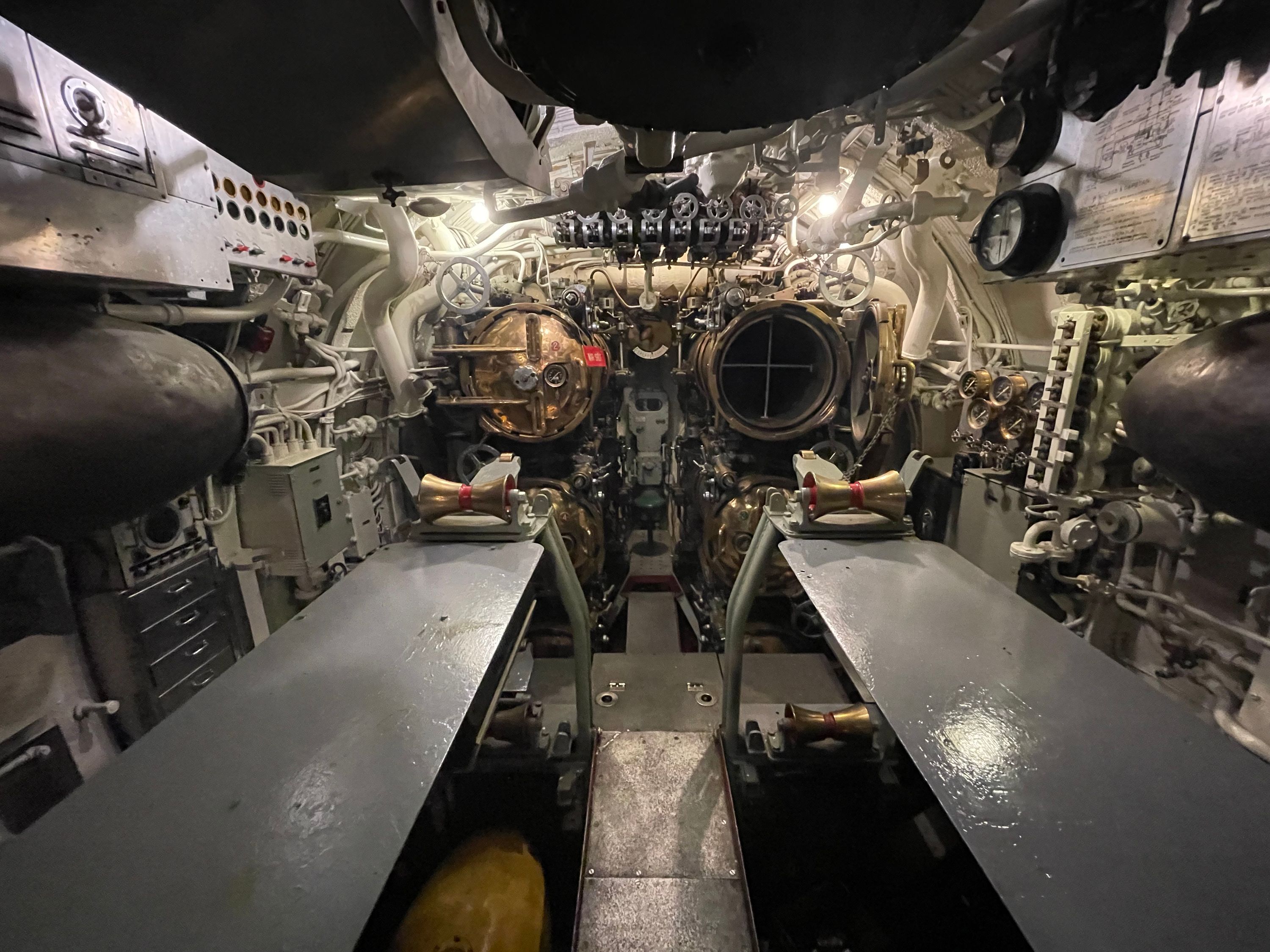 A view of the forward torpedo room. Behind me were a dozen cramped bunks. Can you imagine sleeping soundly next to a giant torpedo?