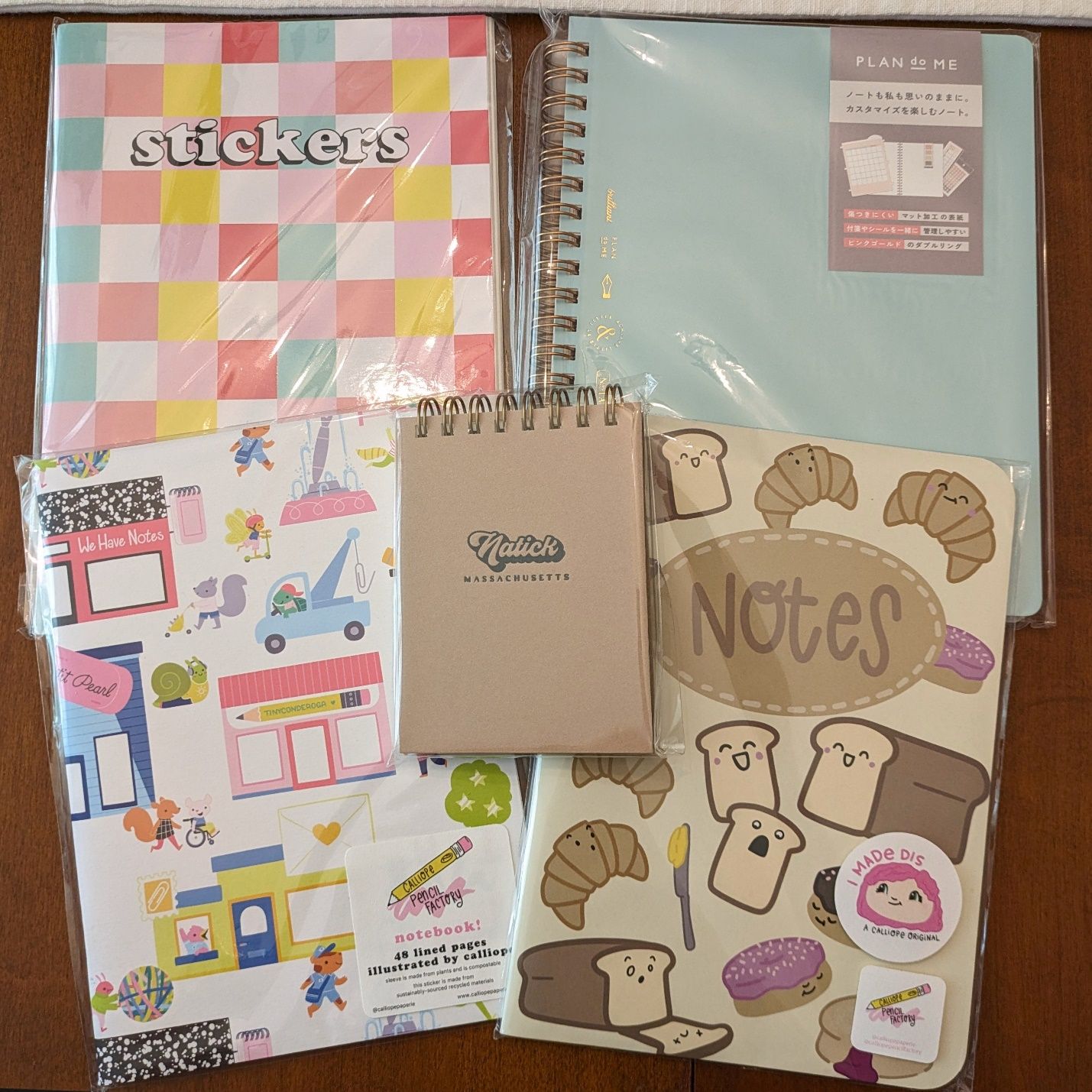 More notebooks. The top left is a sticker album, which I decided I needed so I could organize stickers in a complimentary manner. The cover art on bottom right kills me, which is appropriate since it's called "Murder at the Bakery."