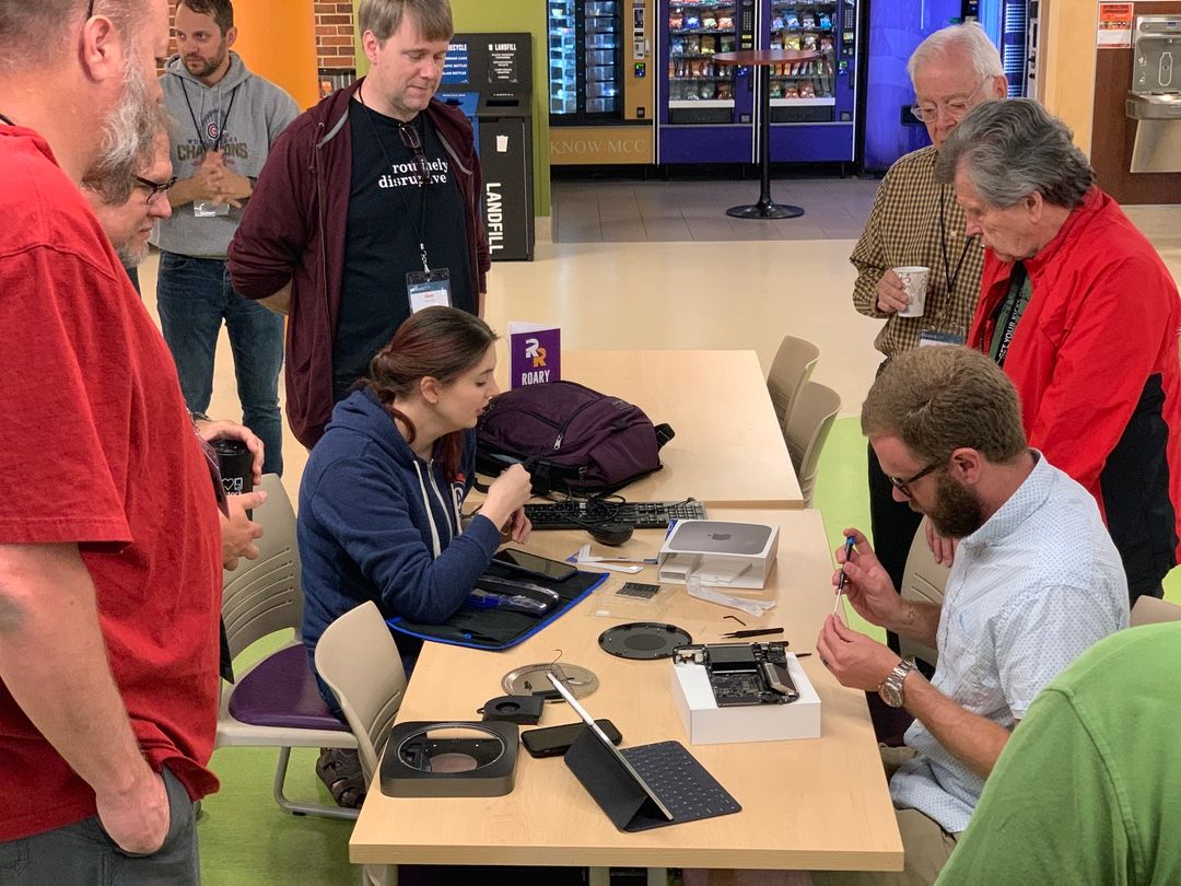 Stephen Hackett disassembling Rosemary Orchard's Mac mini as Rosemary looks on