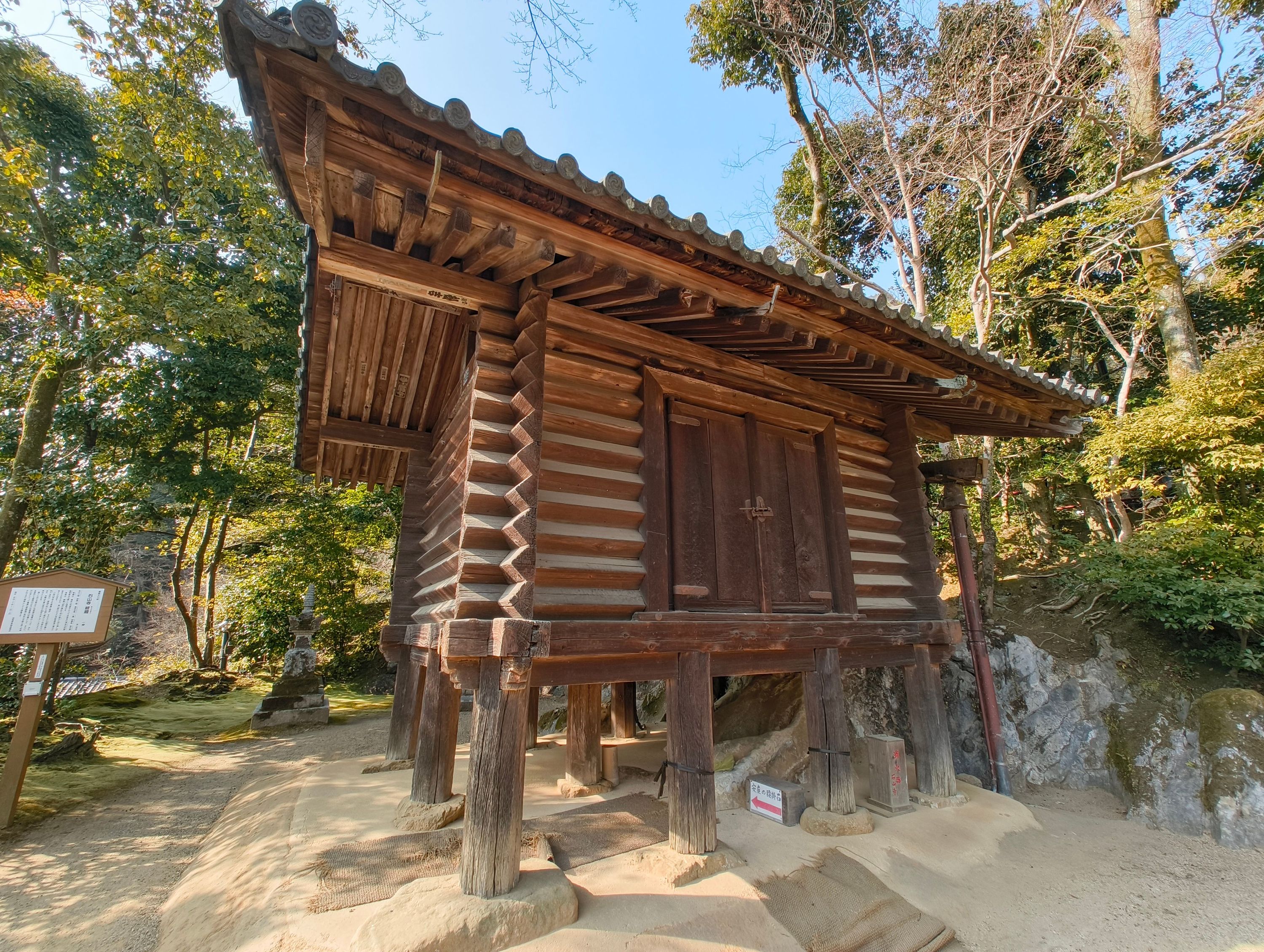 Cool log-cabin style temple-y building. Under this is a magic cushion that, when you sit on it, will bring you luck in childbirth!