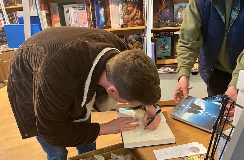 Nick signing books