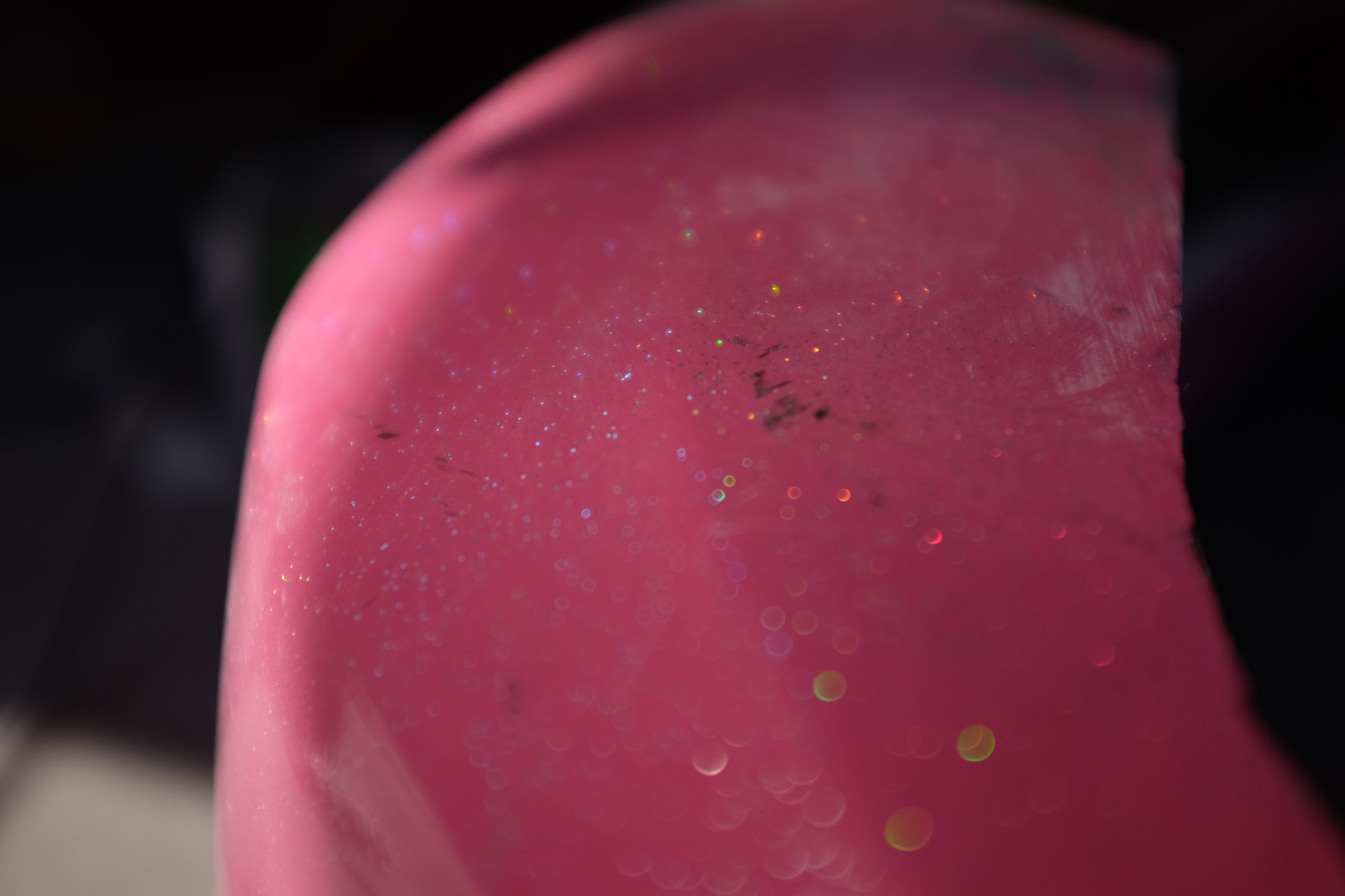 Closeup of a body panel of the Skyline, painted bubble gum pink mixed with glitter.