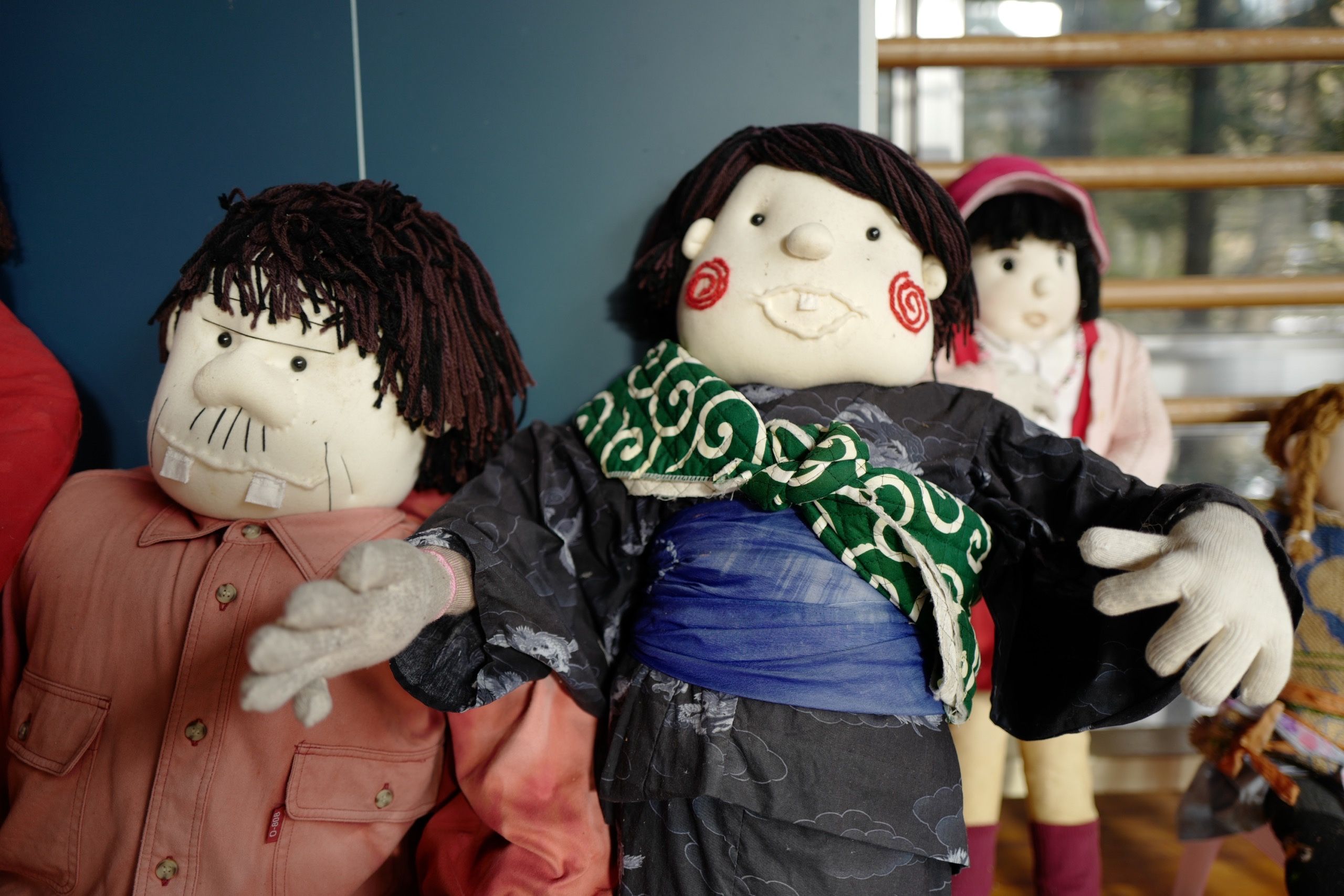 Three human-sized dolls.