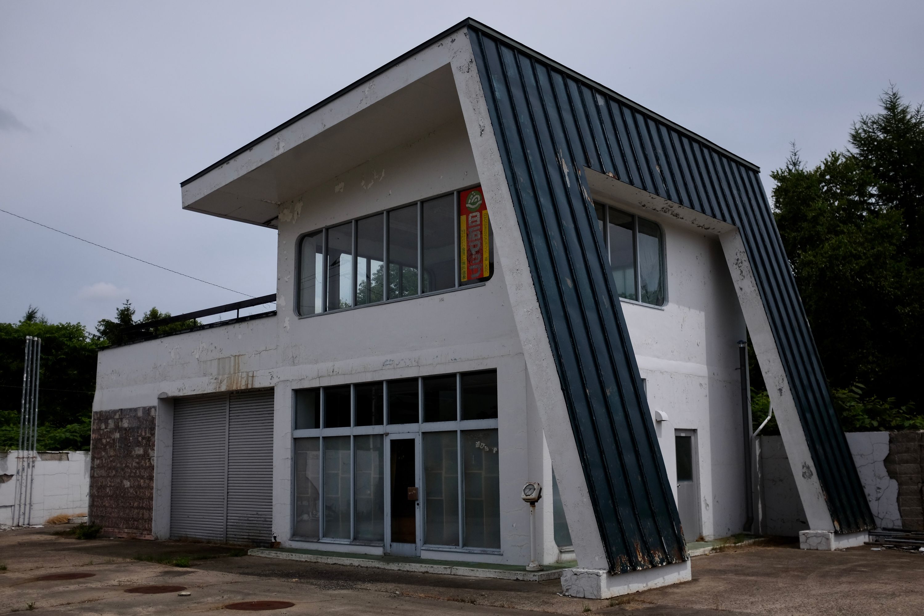 An empty house with a strangely asymmetrical roof.