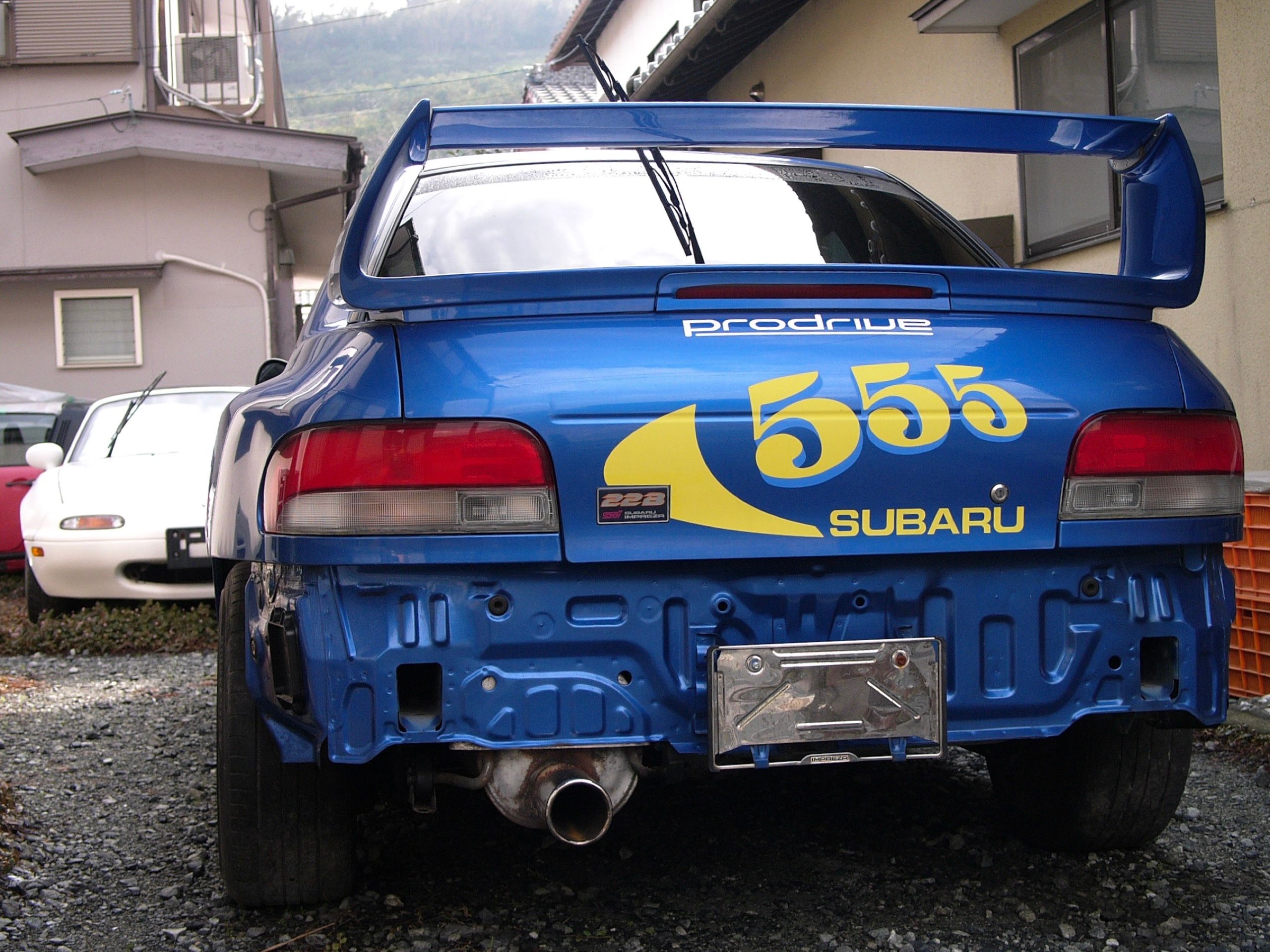 The rear of a Subaru Impreza rally car in Colin McRae’s 555 livery.