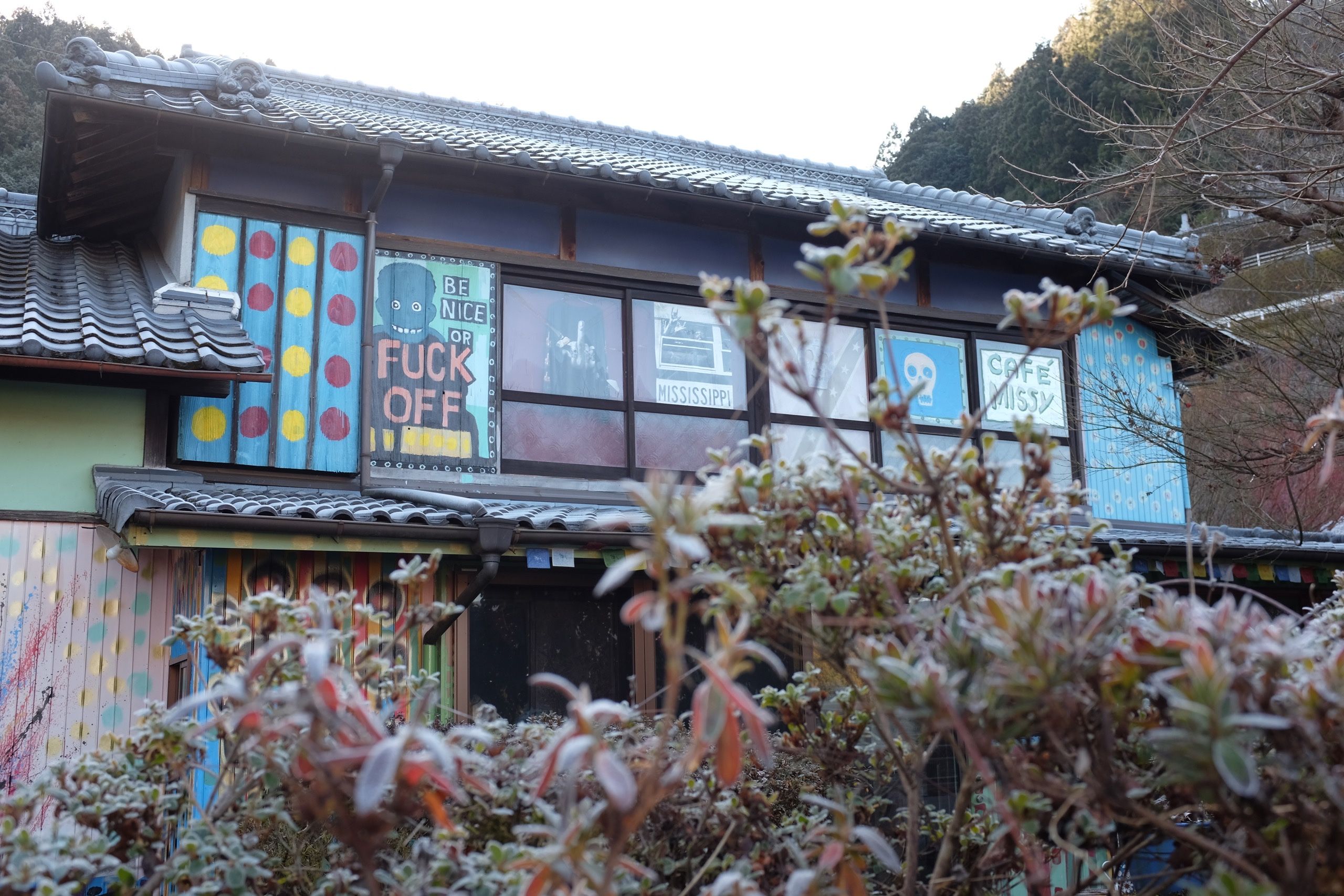 A Japanese house turned into an American South-themed bar on a cold winter morning, with a sign saying: Be Nice or Fuck Off.