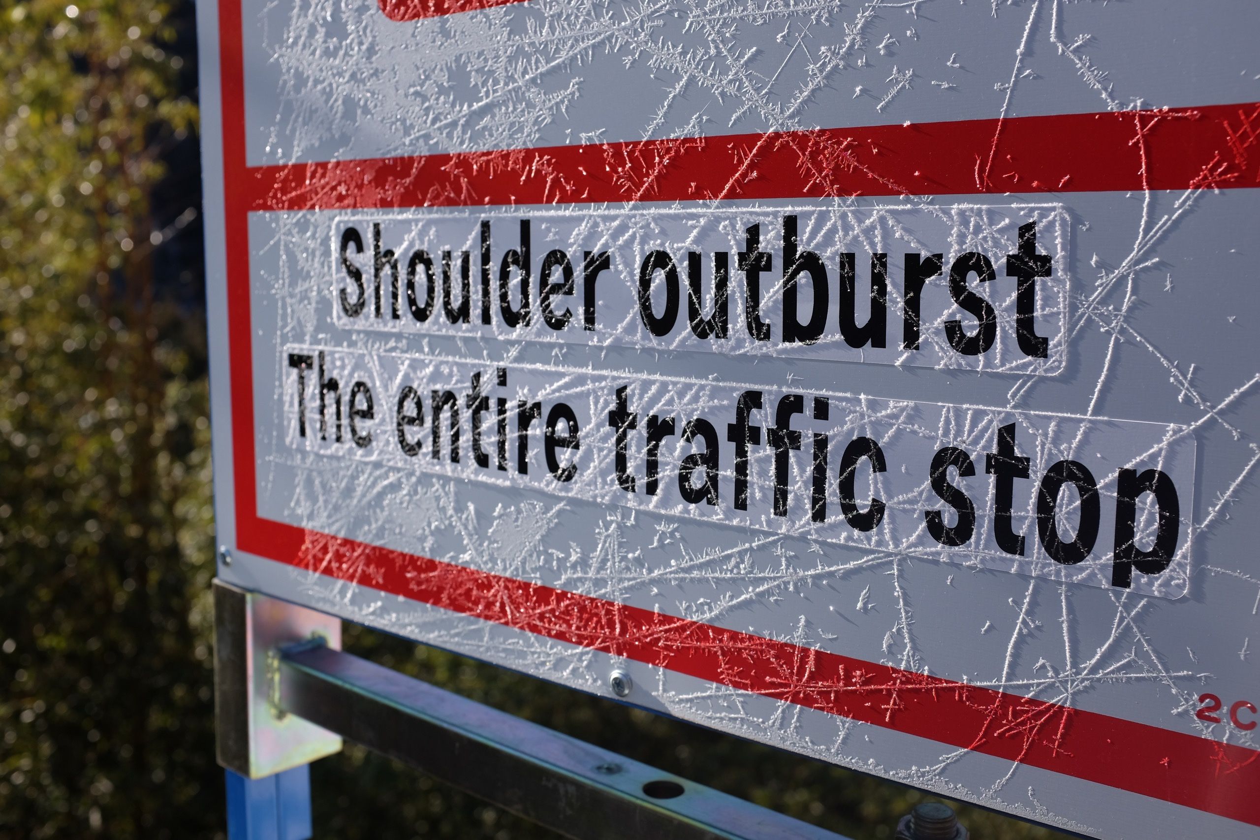 A frozen sign that says: Shoulder outburst, The entire traffic stop.