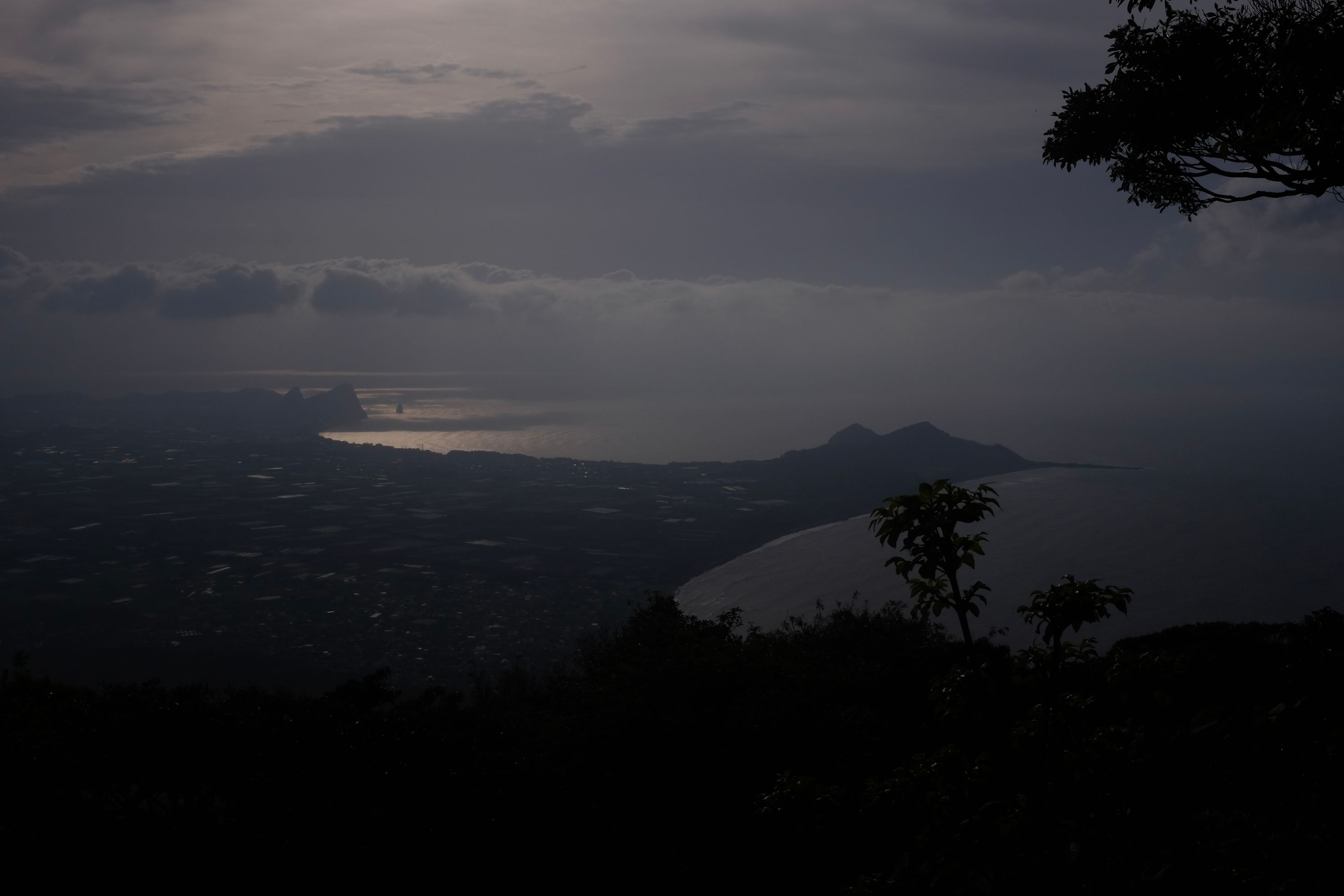 The view down on the sea and a largely flat landscape.