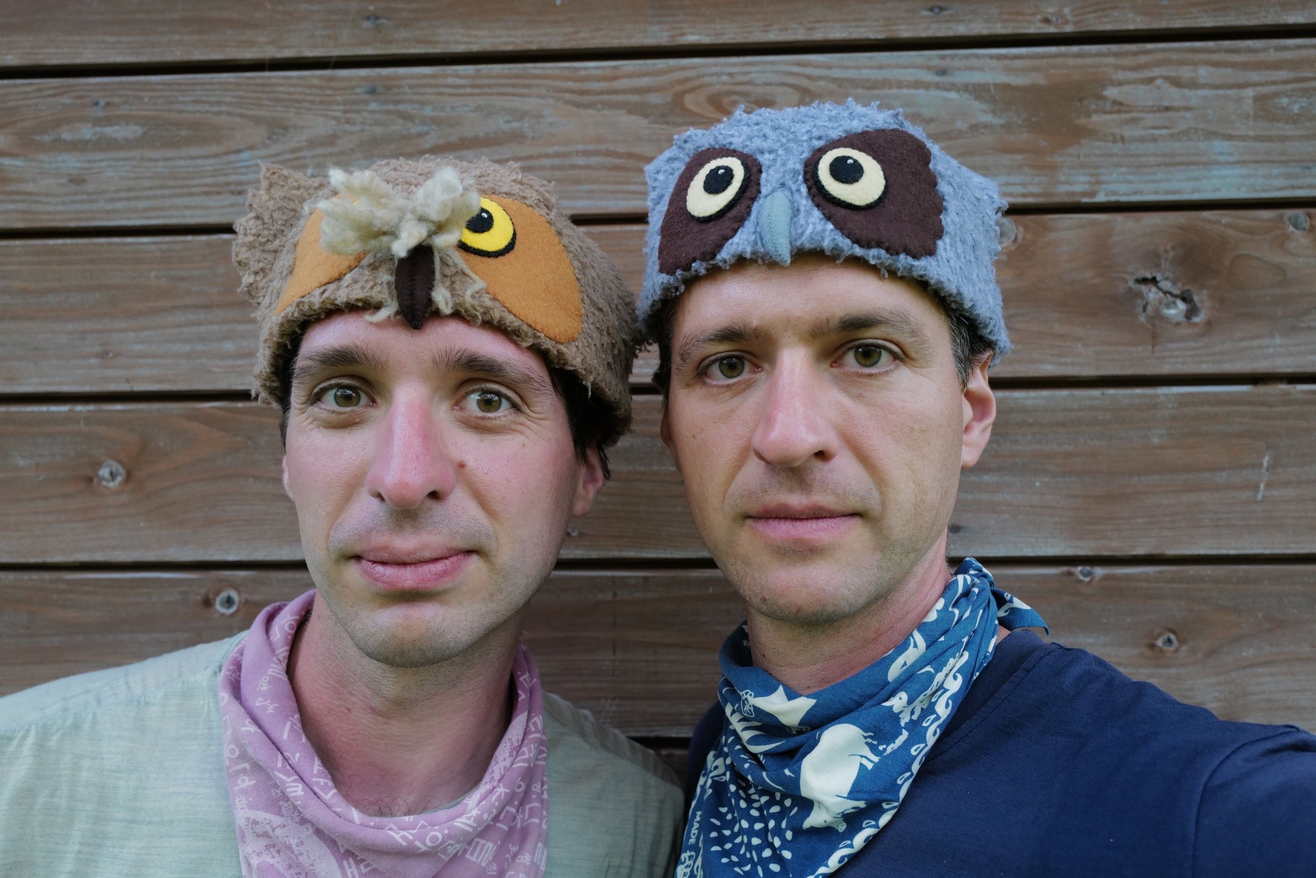 Gabor and Peter Orosz, wearing owl hats, look into the camera