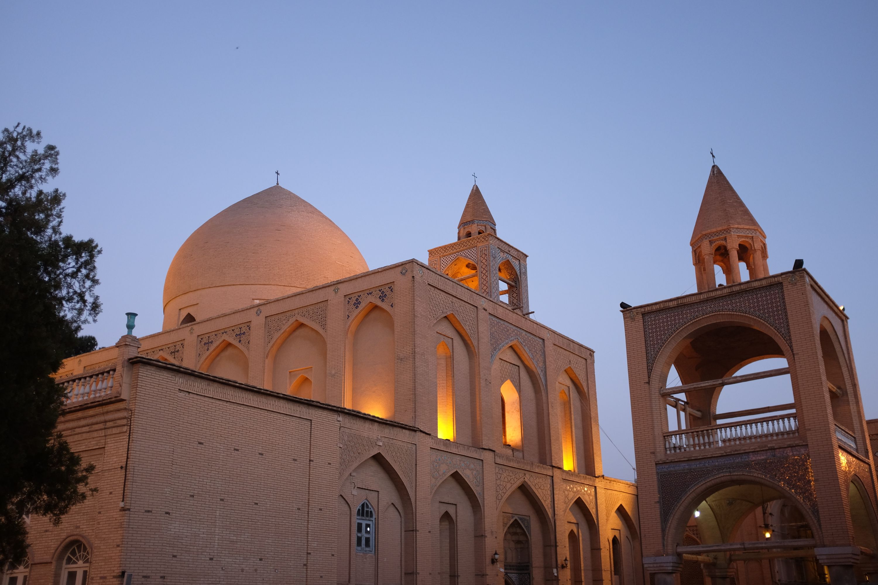 The main building of an Armenian cathedral in the evening light, with a large, undecorated dome.