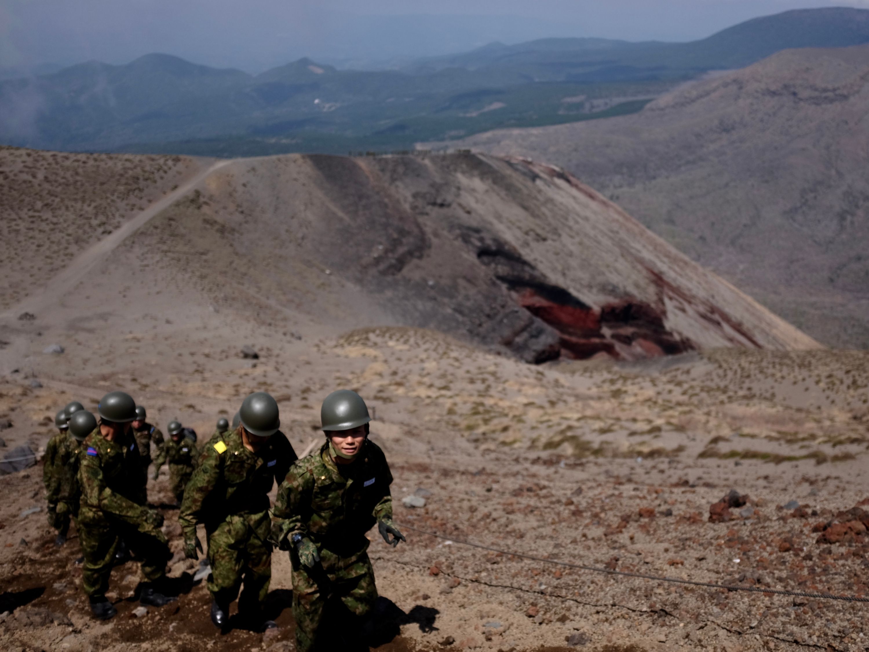 The same soldiers on their way up, one of them looking into the camera.