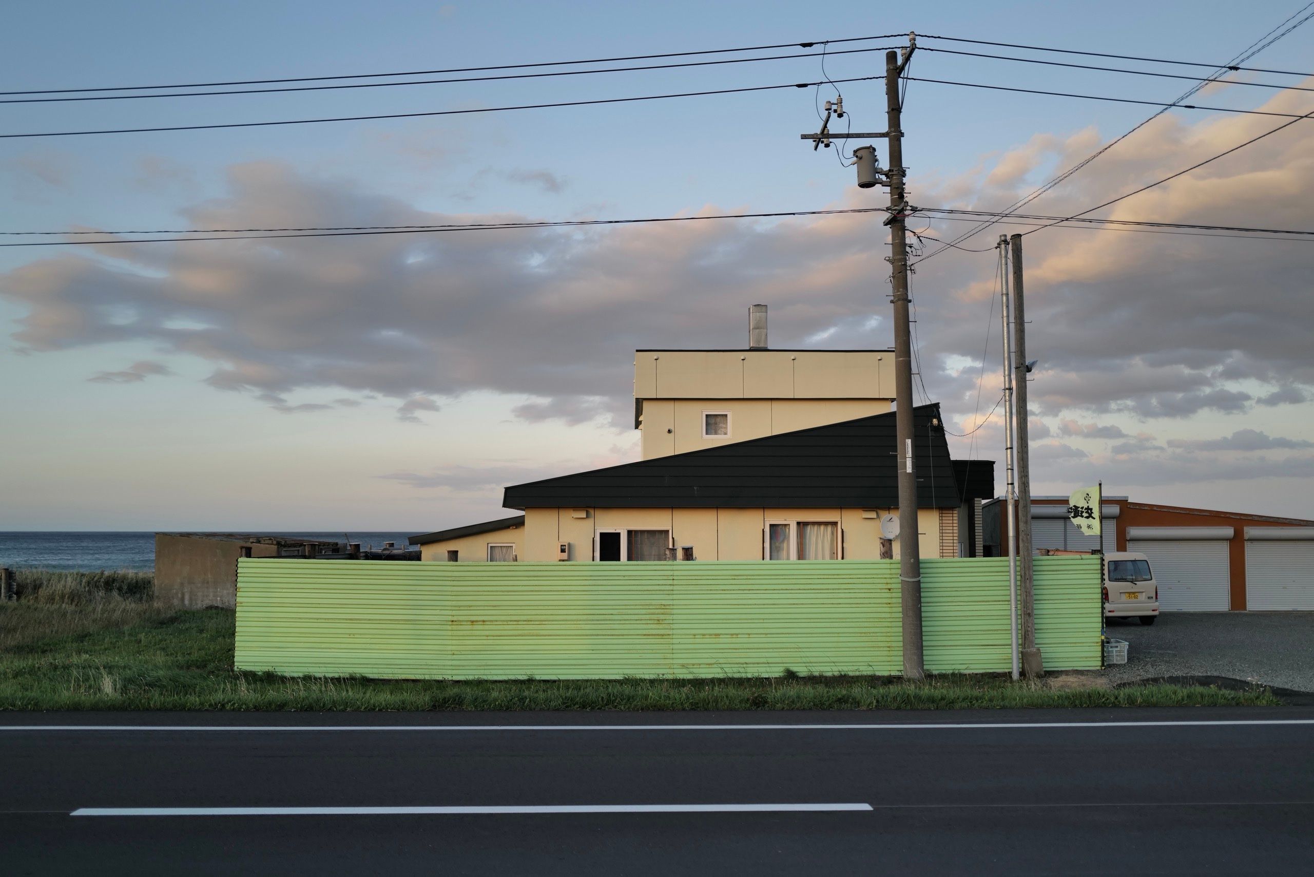 A house surrounded by corrugated aluminium sheets against the wind