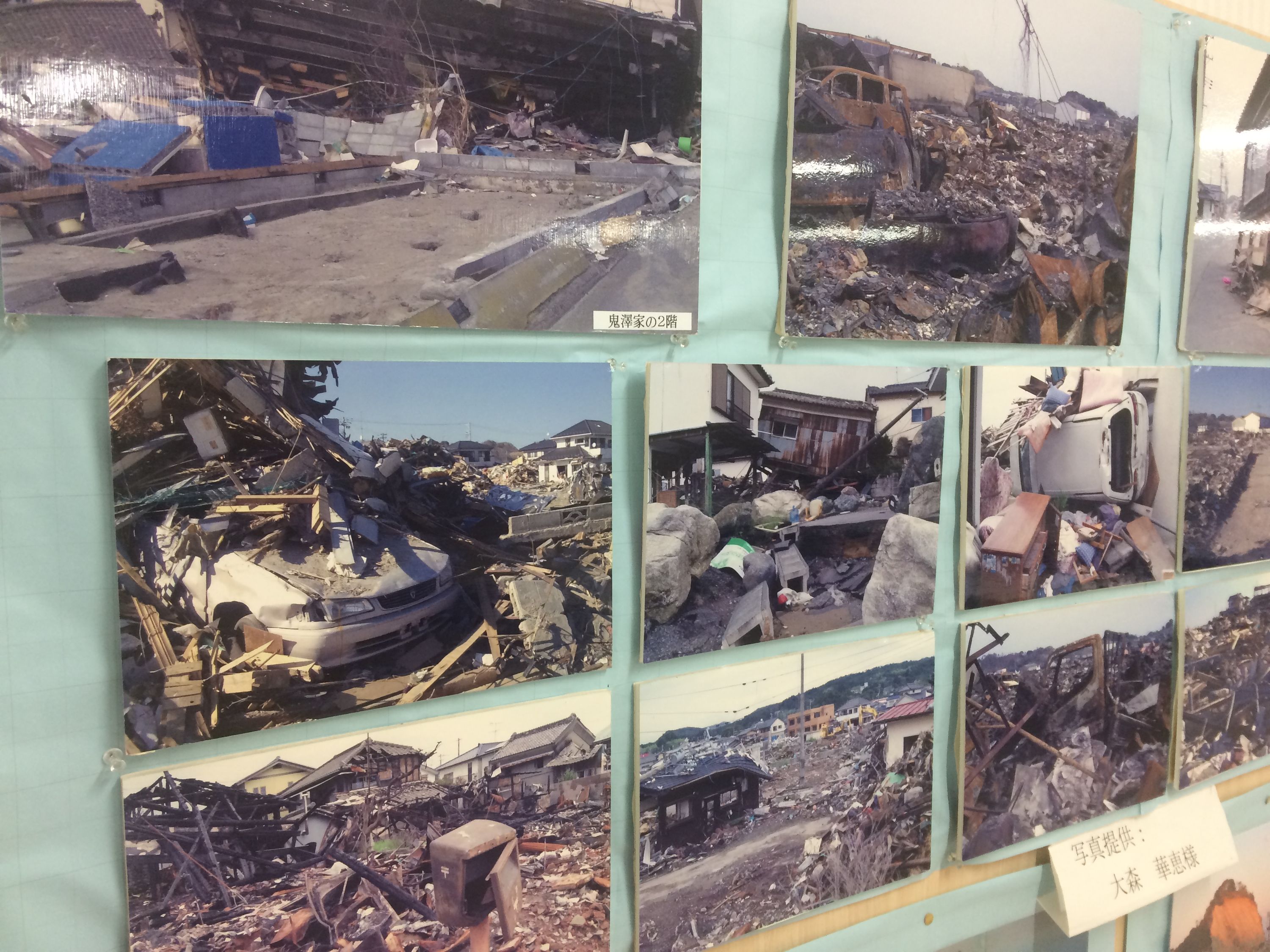 Pictures on a wall show the utter devastation of Hisanohama after the tsunami.