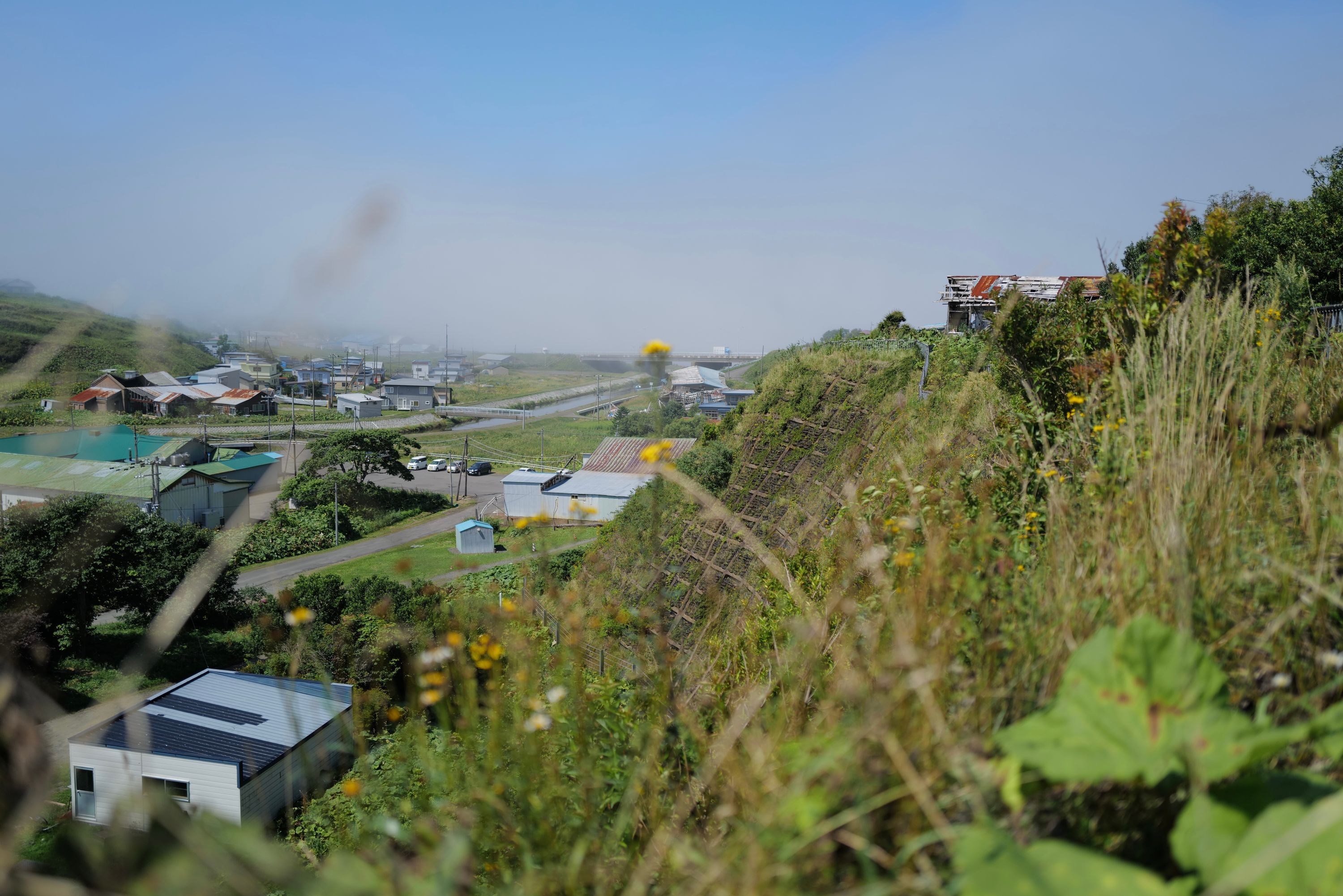 Looking out over some buildings with a wall of fog on the horizon.