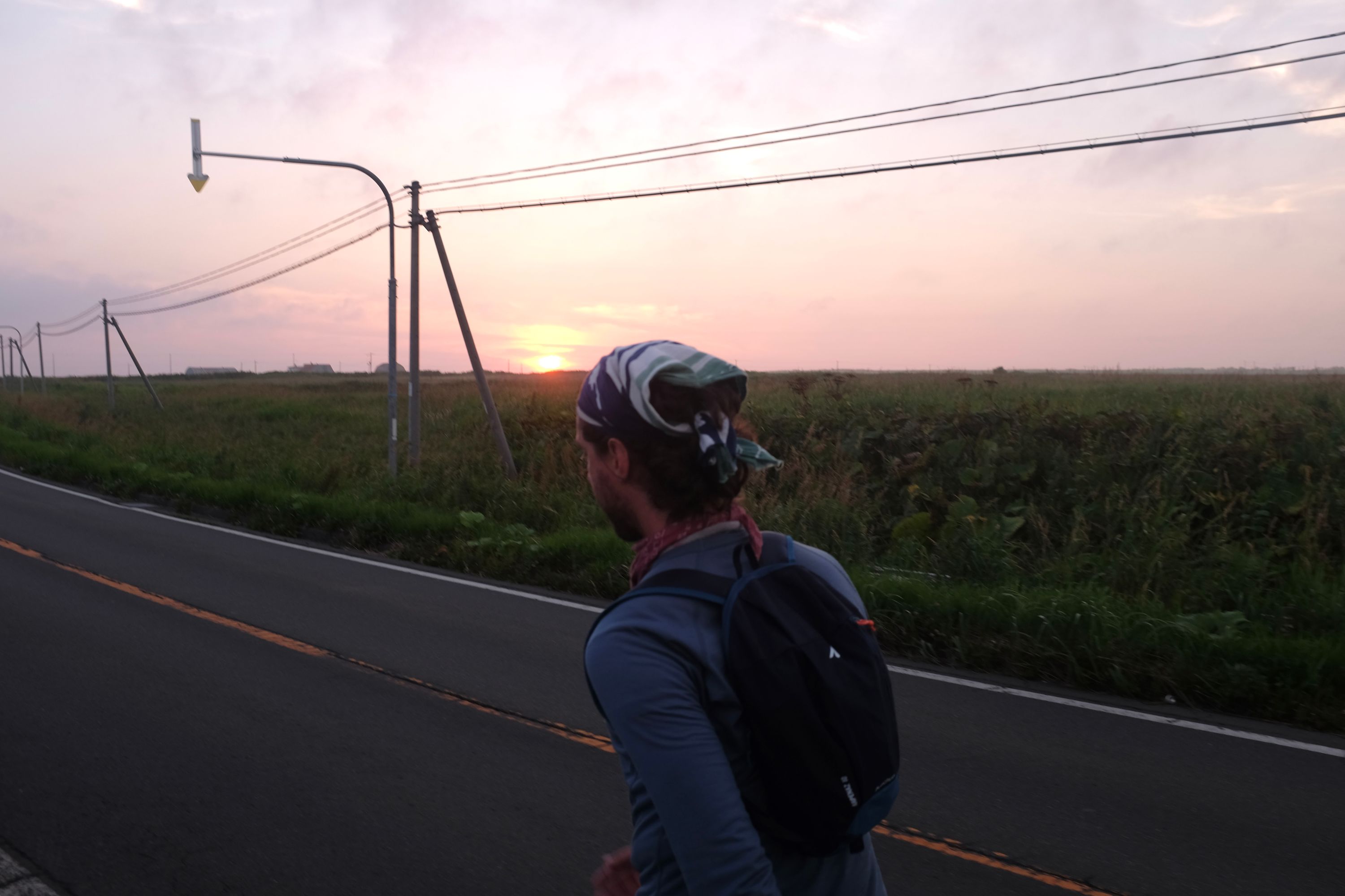 Gabor walks on a road in the evening light.