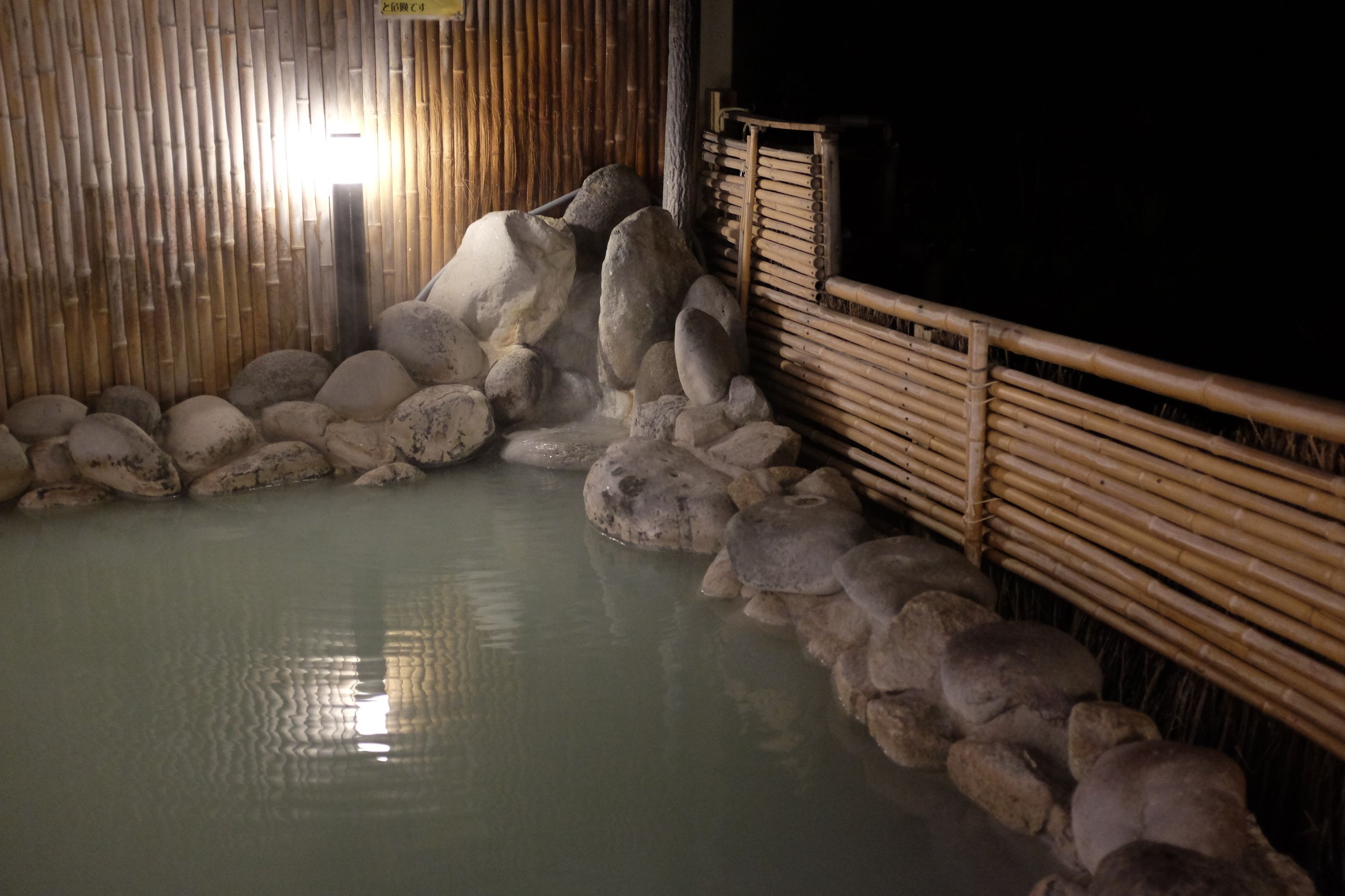 The cloudy waters of the outside pool of a bathhouse.