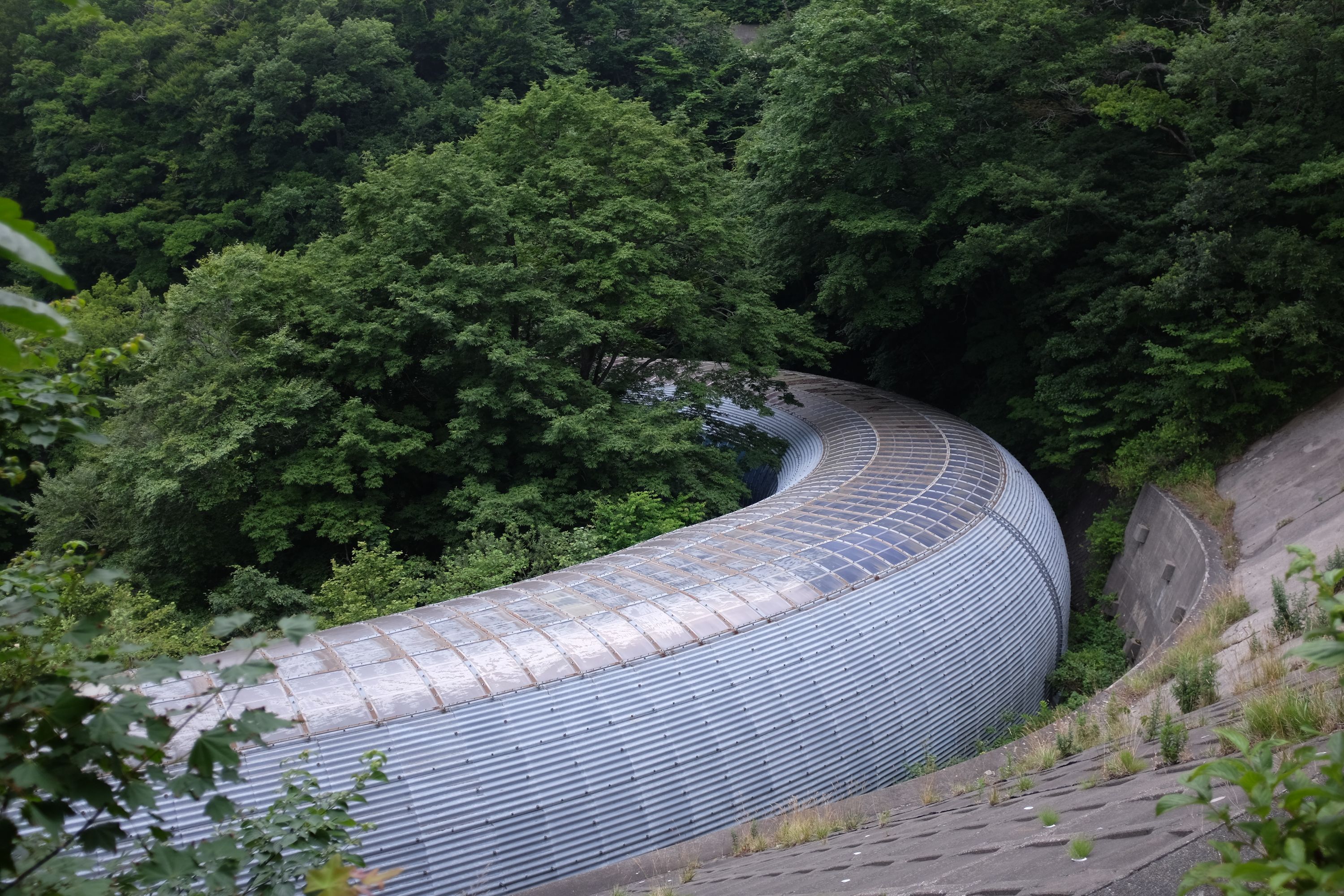Looking down on the same tunnel from above. It looks like a large, metallic tube.